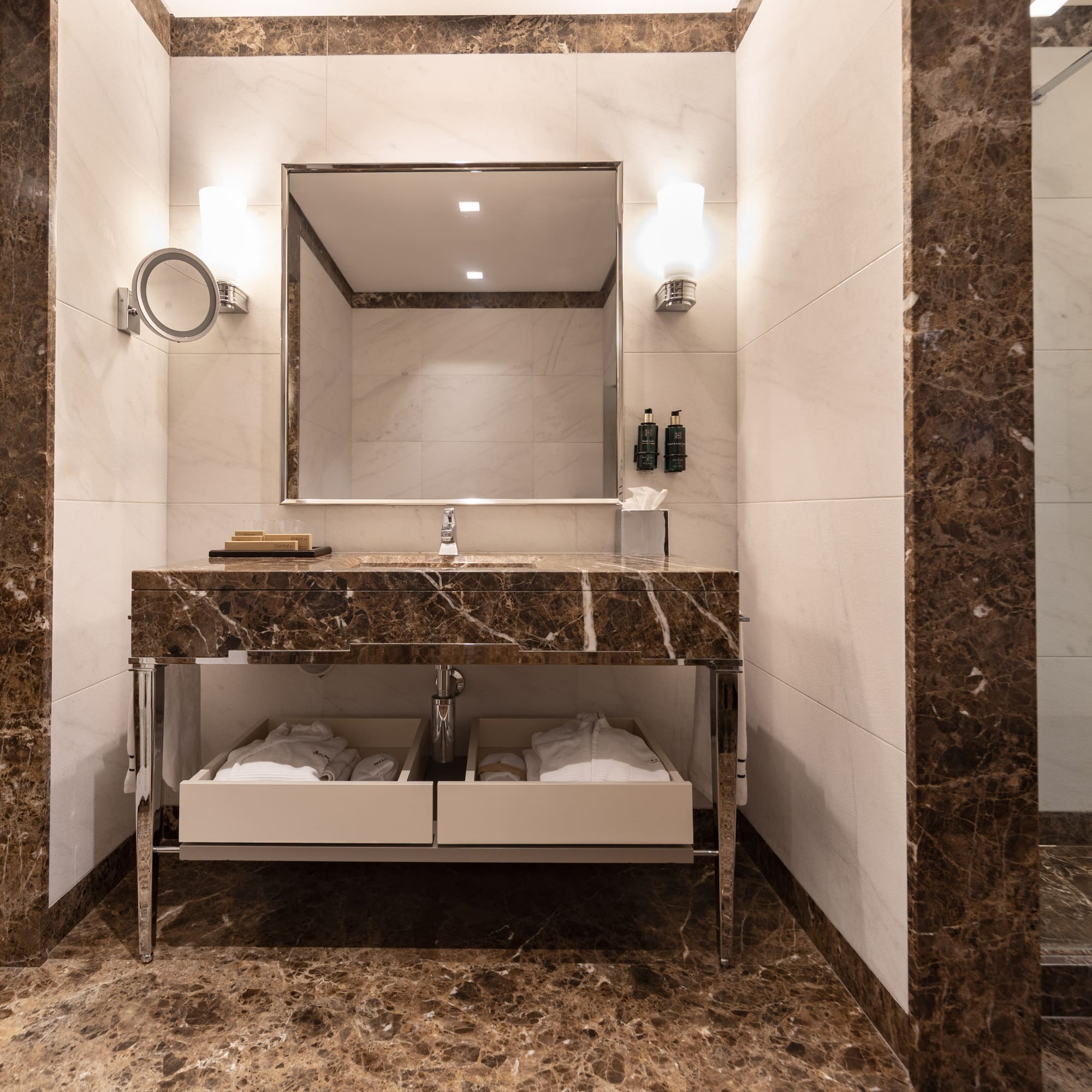 a bathroom with a marble countertop and a mirror