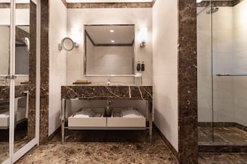 a bathroom with a marble countertop and a mirror