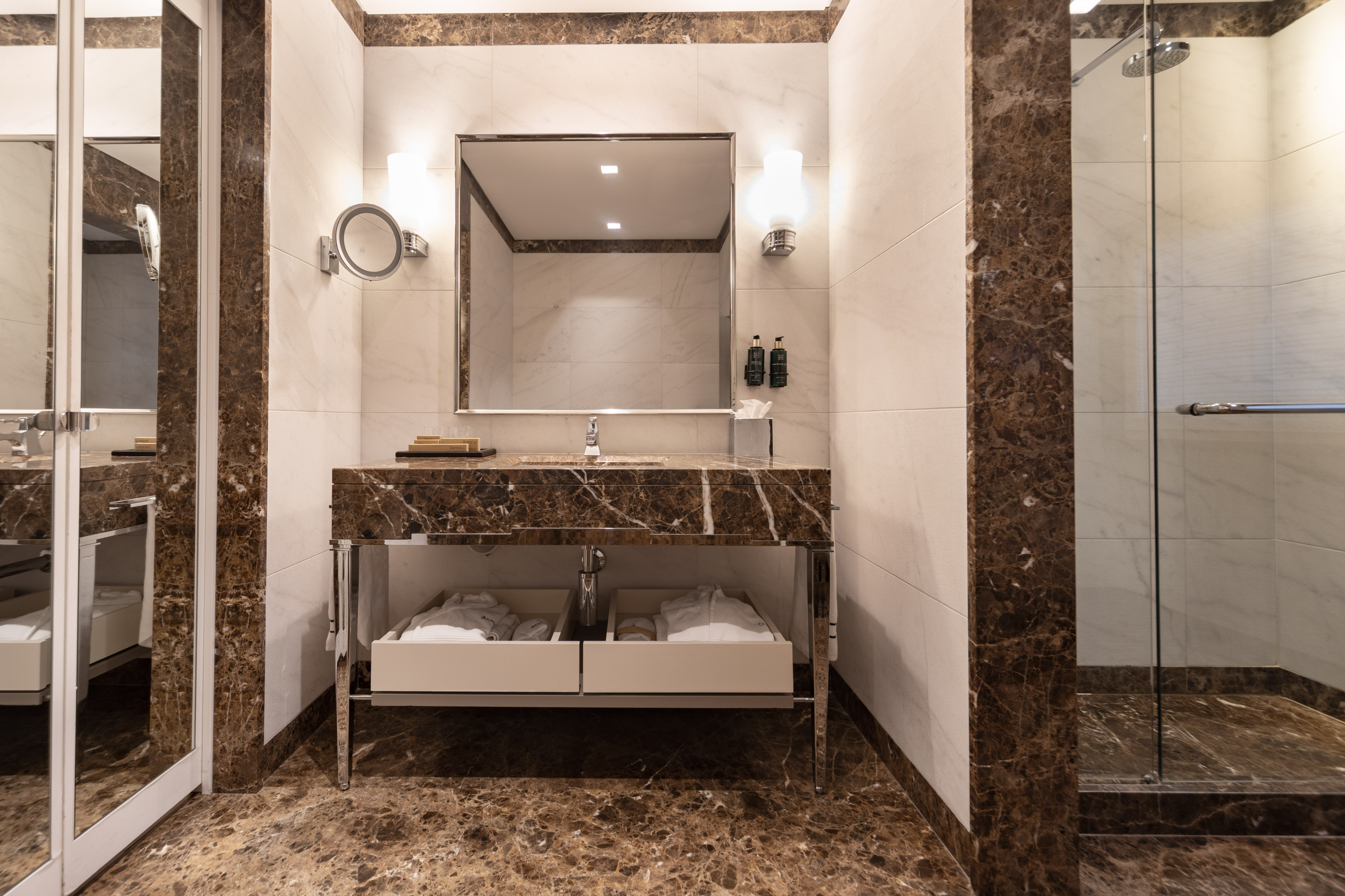Luxury hotel bathroom with brown marble vanity, large mirror, and glass shower. - Supreme Room - Meliá Genova, Genua