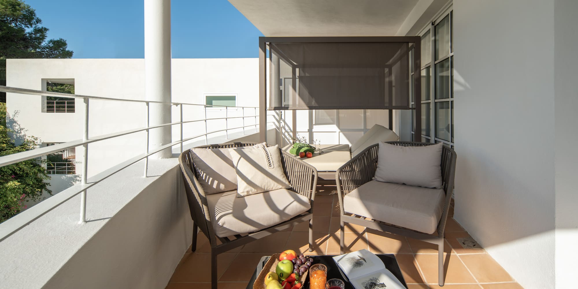 a patio with chairs and a table
