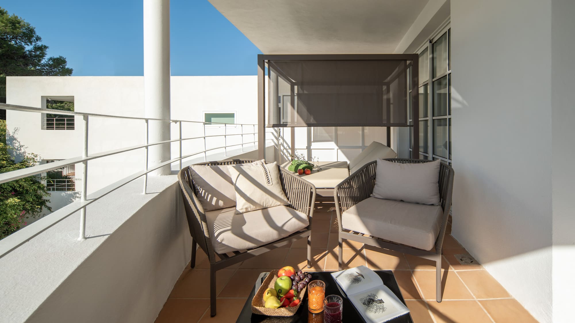 a patio with chairs and a table