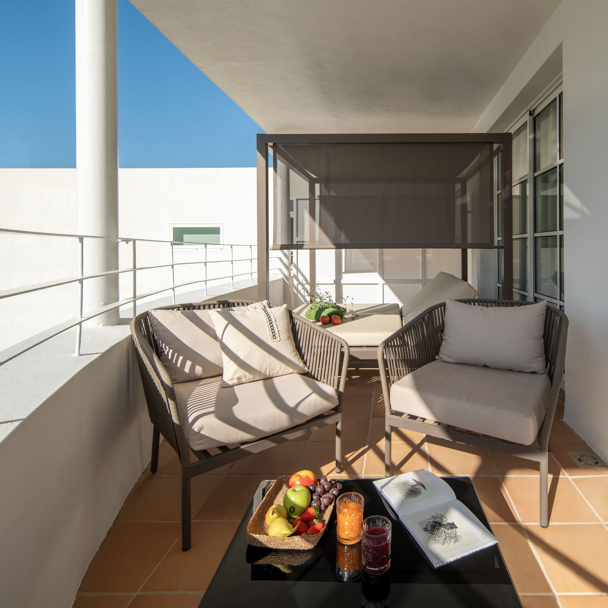 a patio with chairs and a table