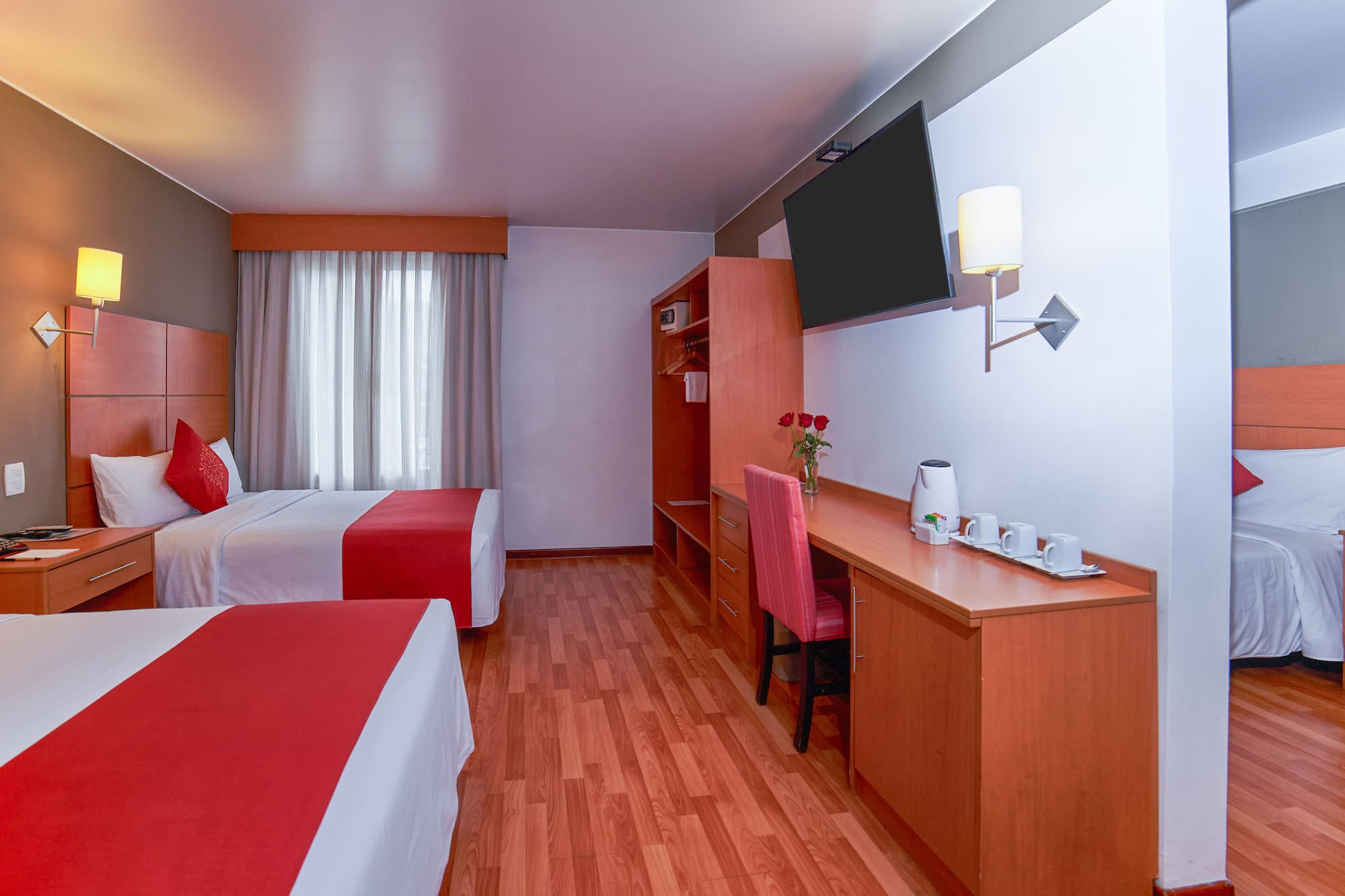 a room with two beds and a desk