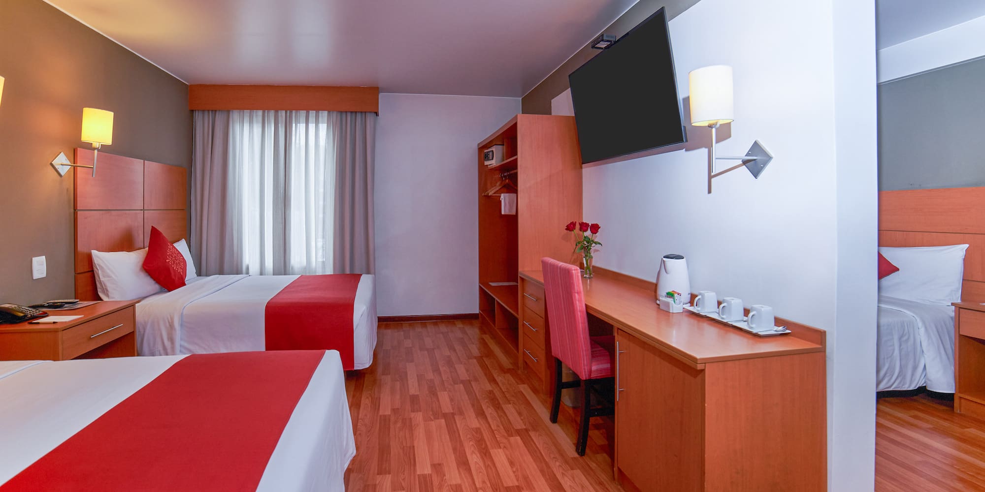 a room with two beds and a desk