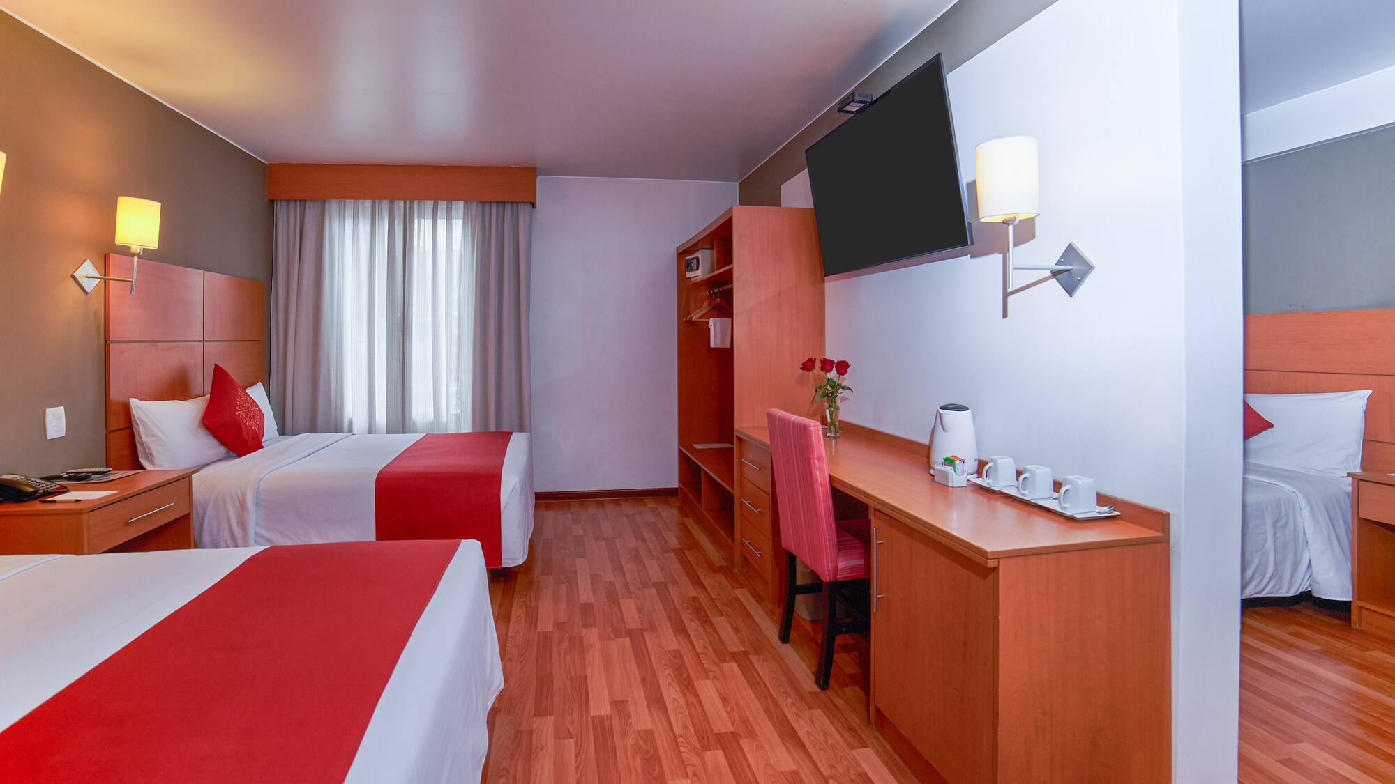 a room with two beds and a desk