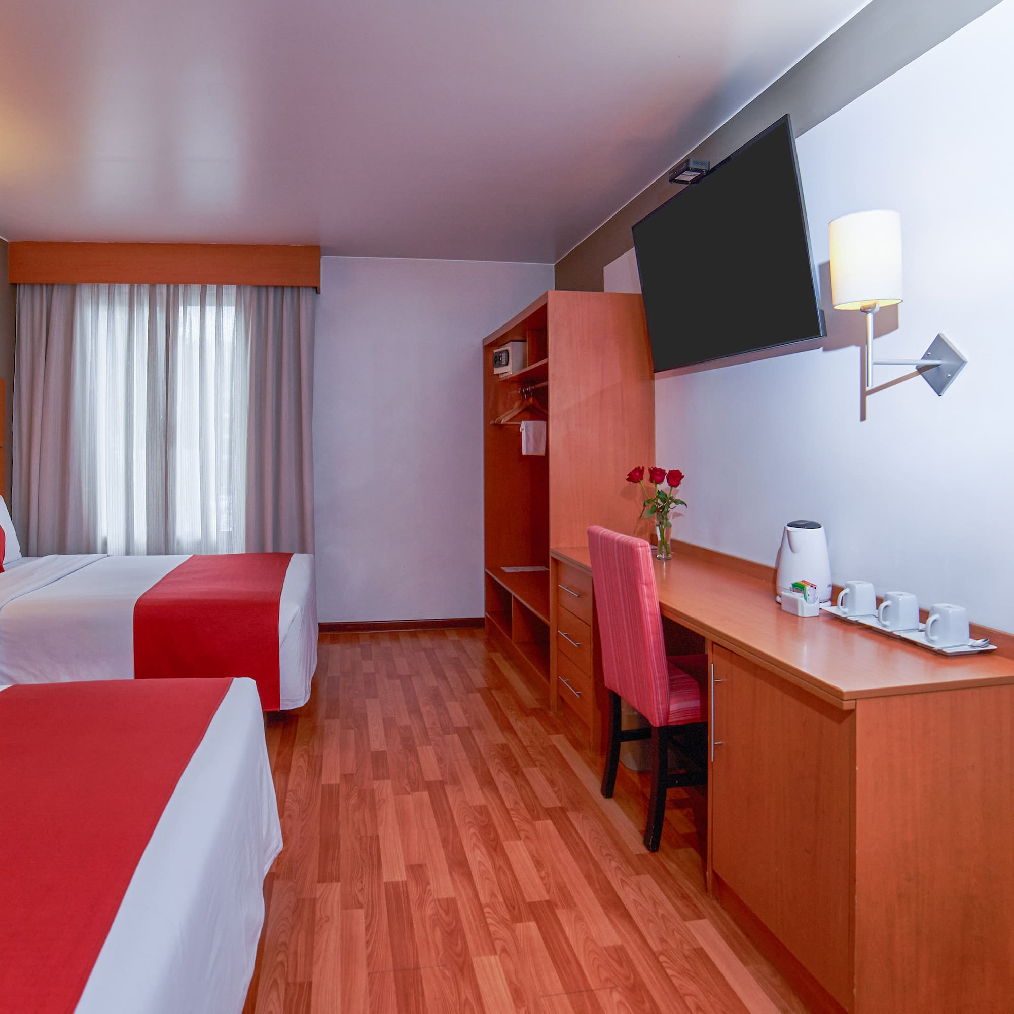 a room with two beds and a desk