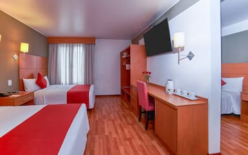 a room with two beds and a desk