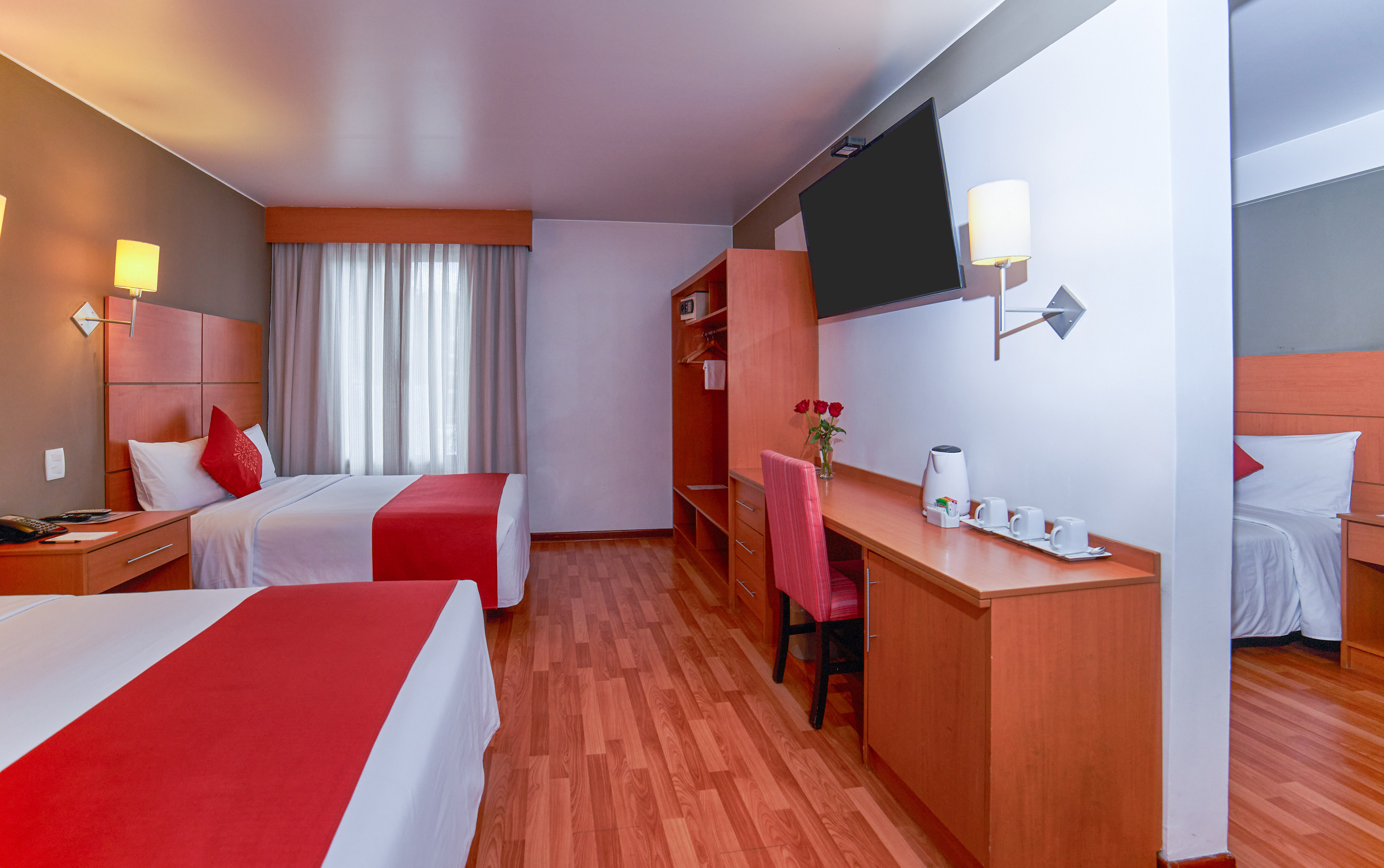a room with two beds and a desk