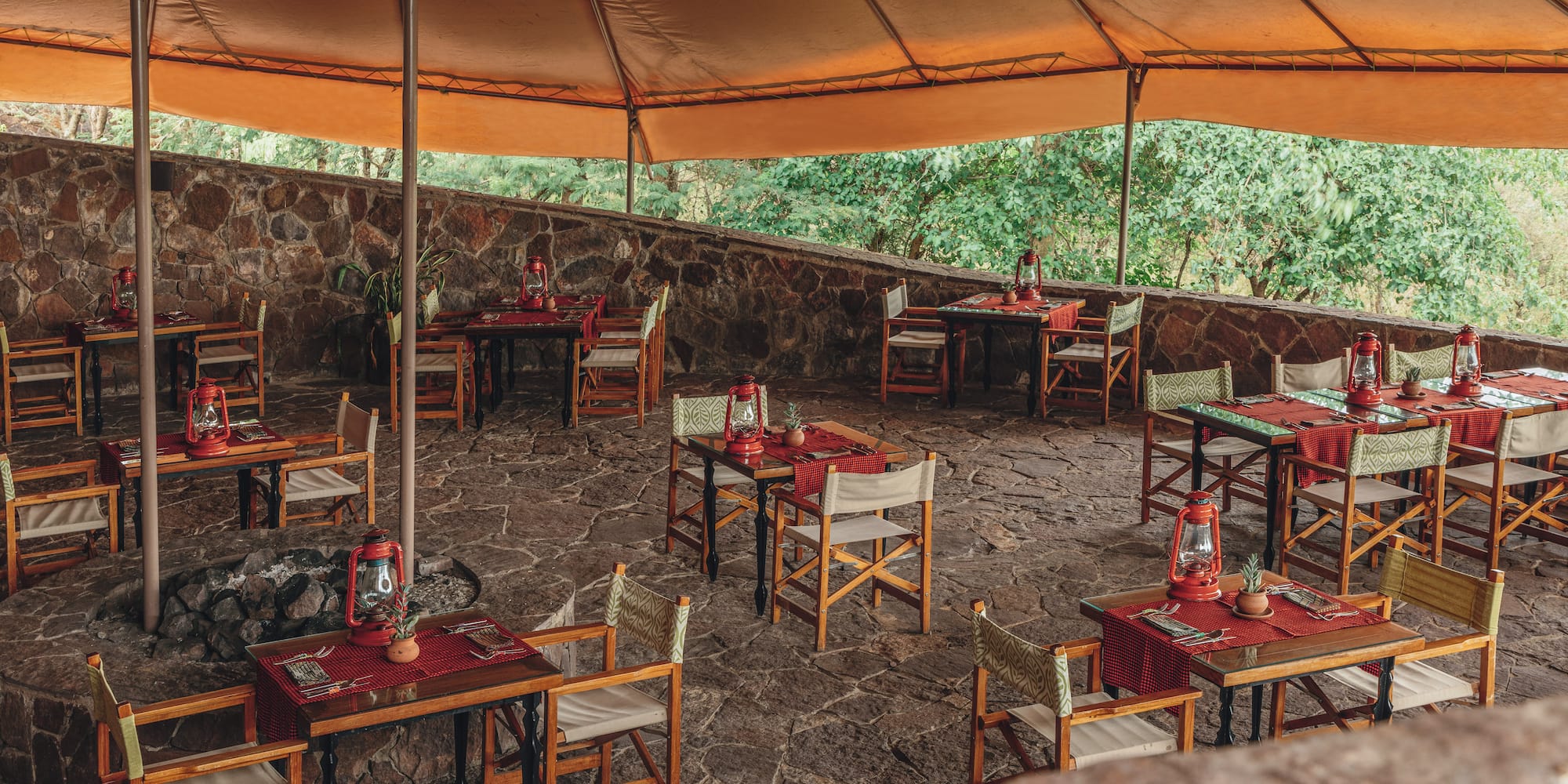 a table and chairs under a tent