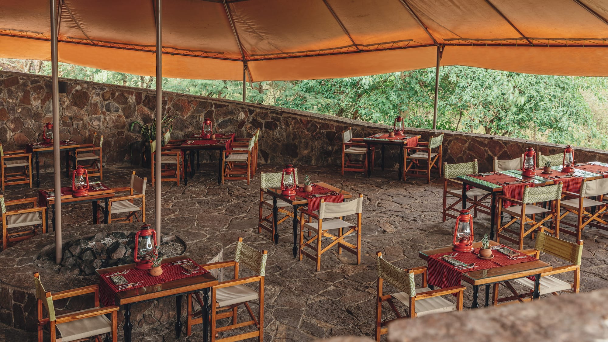 a table and chairs under a tent