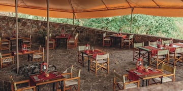 a table and chairs under a tent