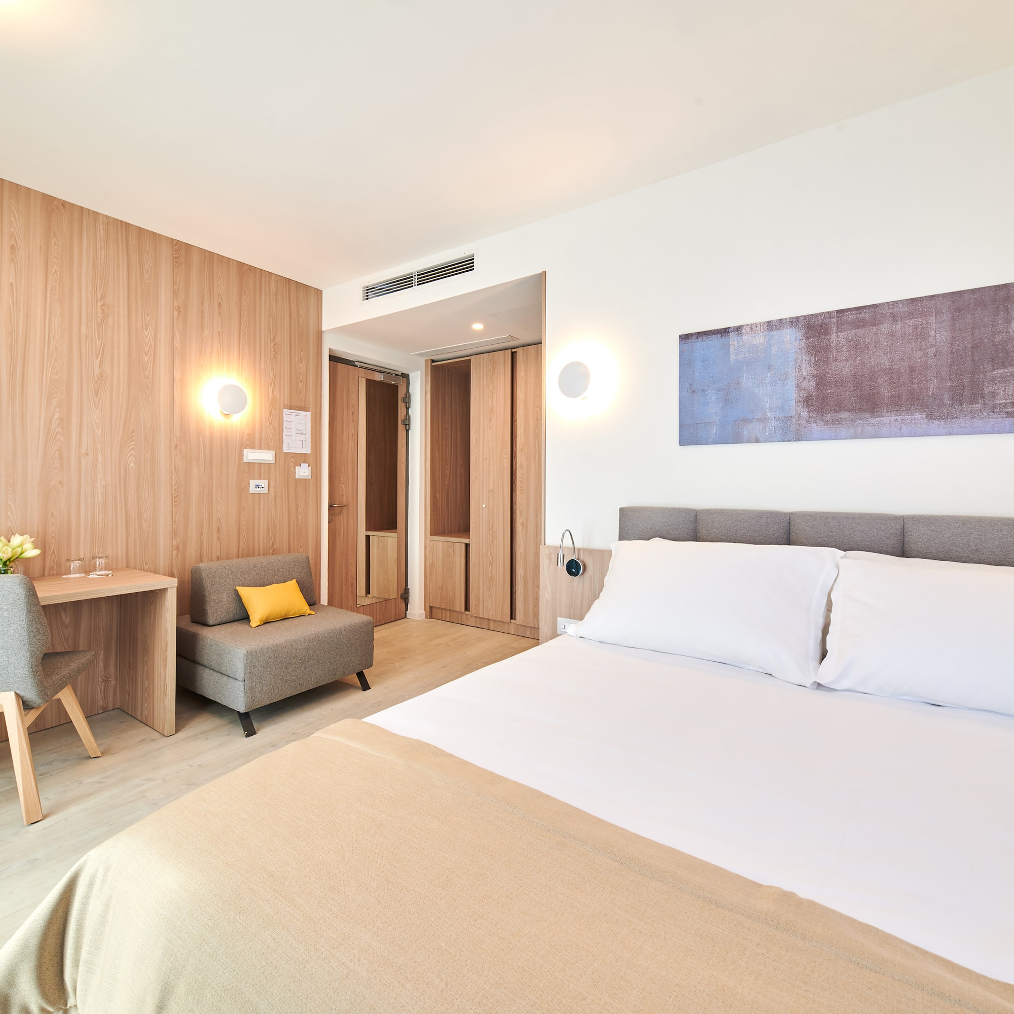 a bedroom with a bed and a chair