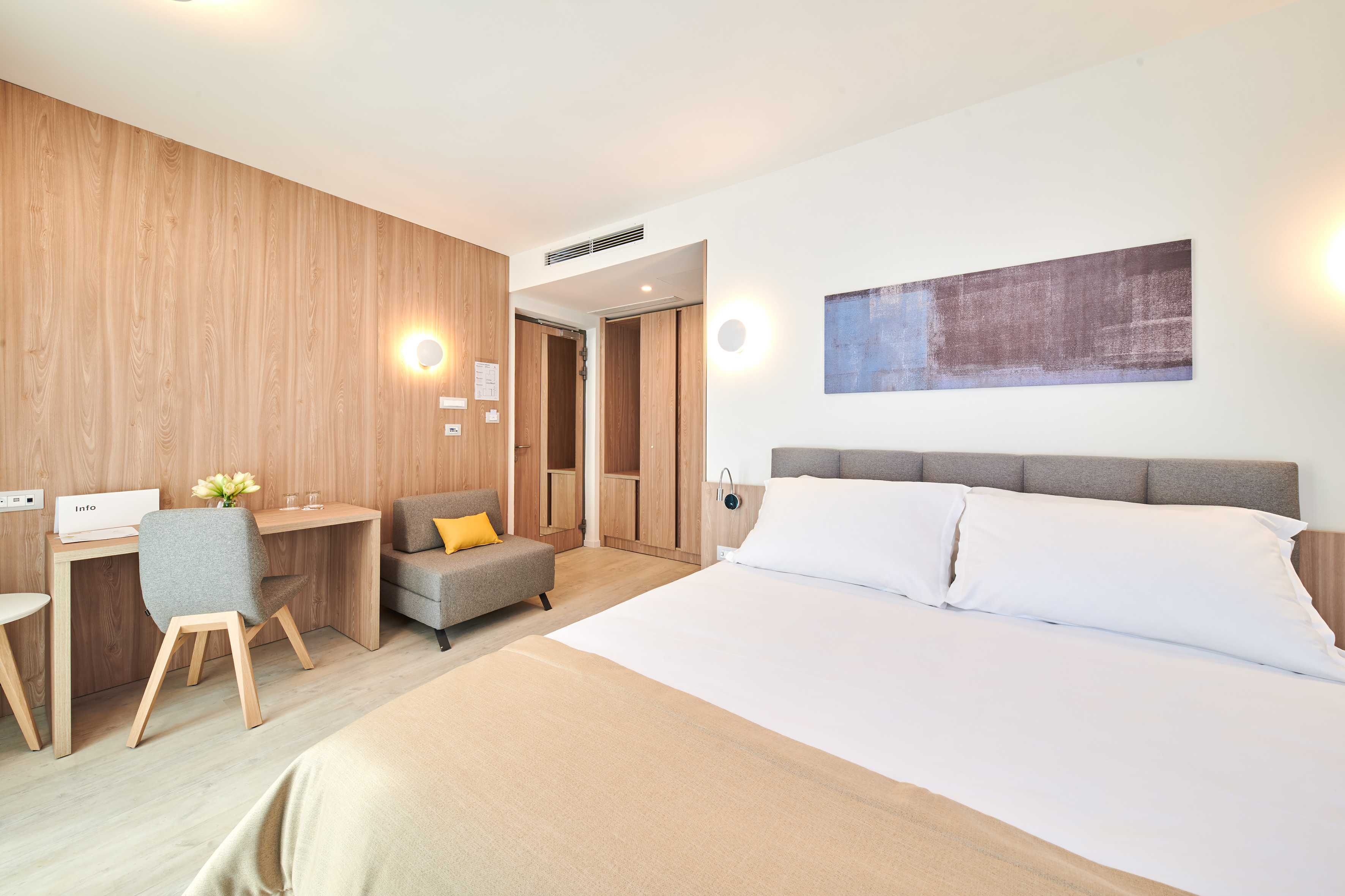 a bedroom with a bed and a chair