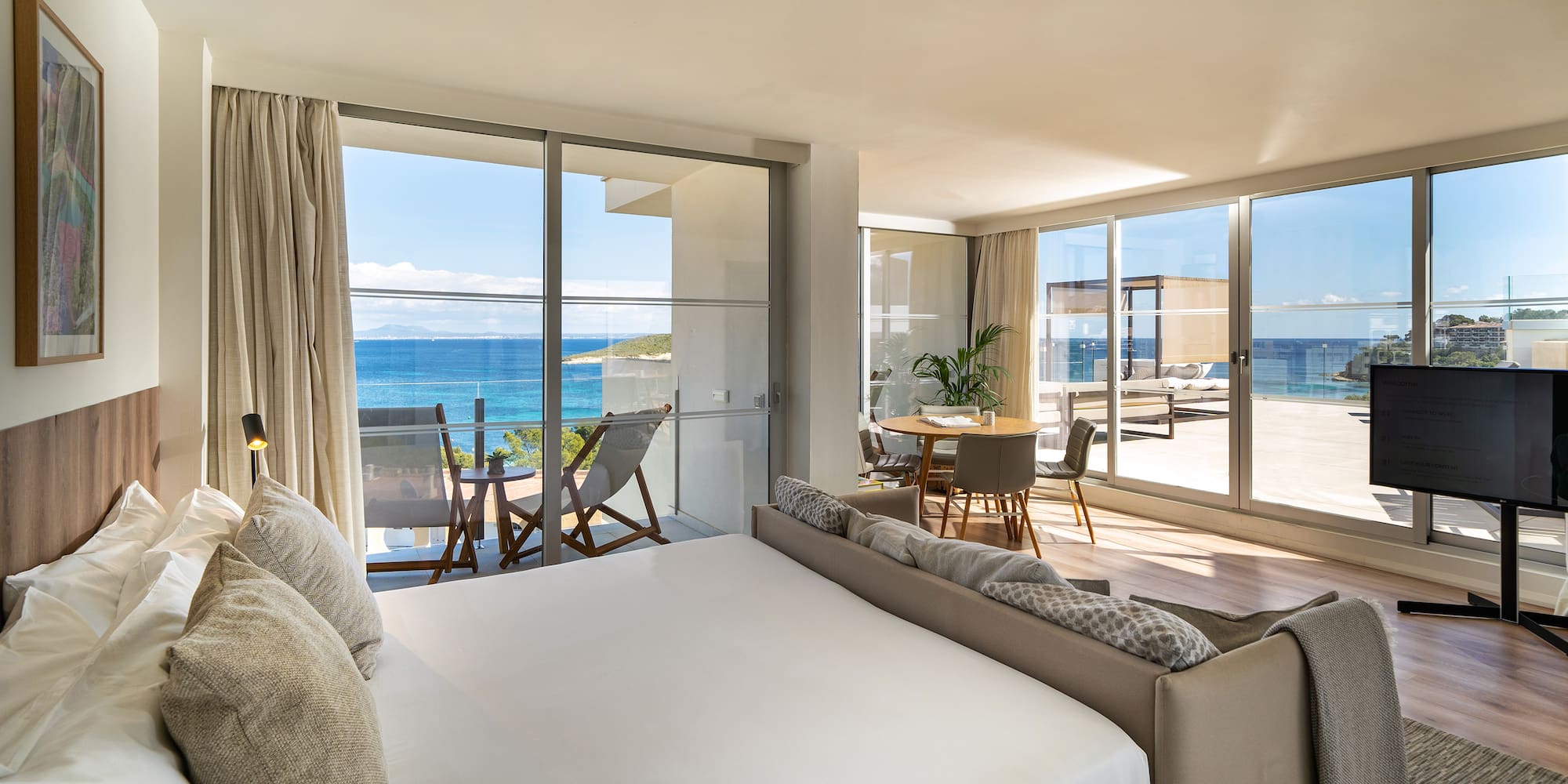 a bedroom with a large window overlooking the ocean