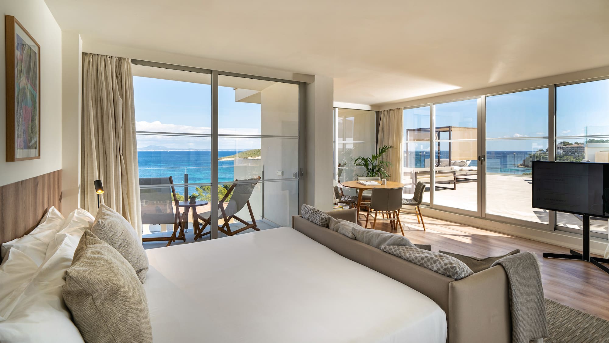 a bedroom with a large window overlooking the ocean