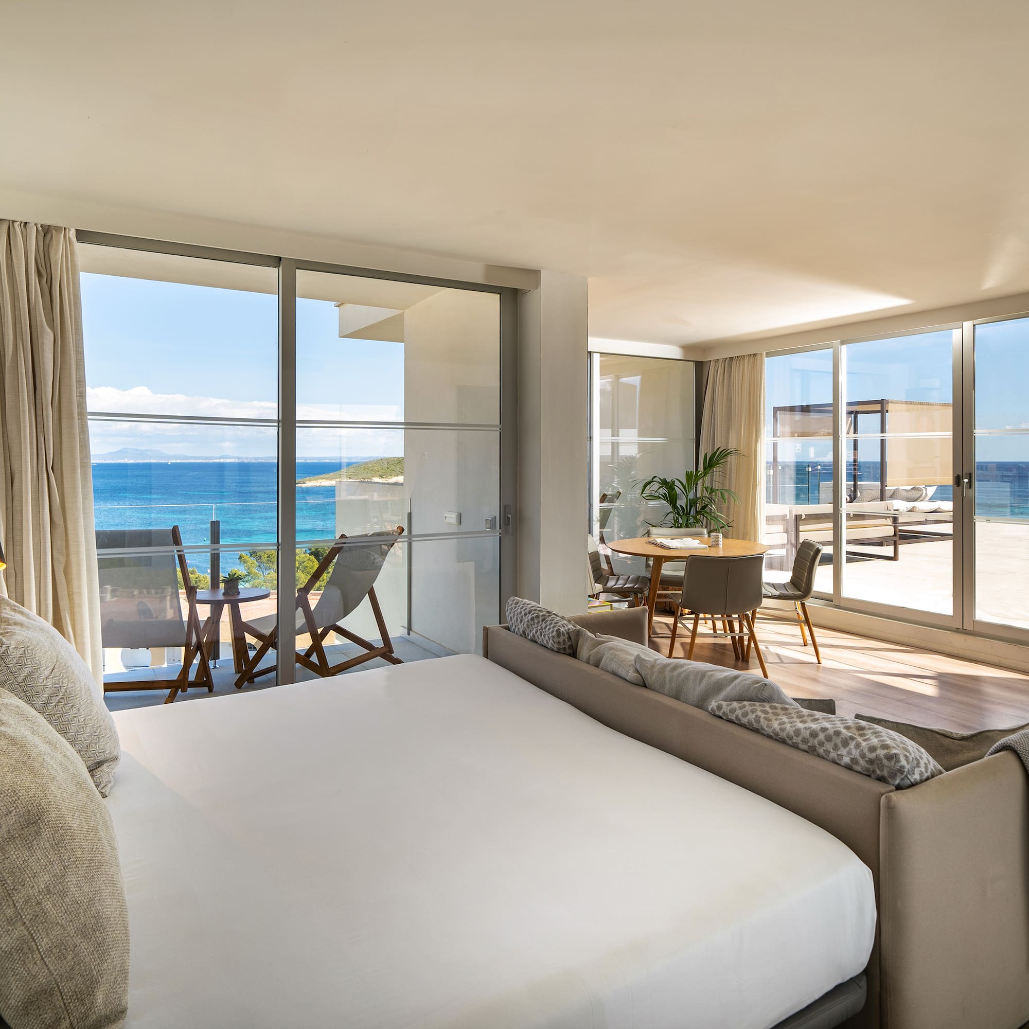 a bedroom with a large window overlooking the ocean