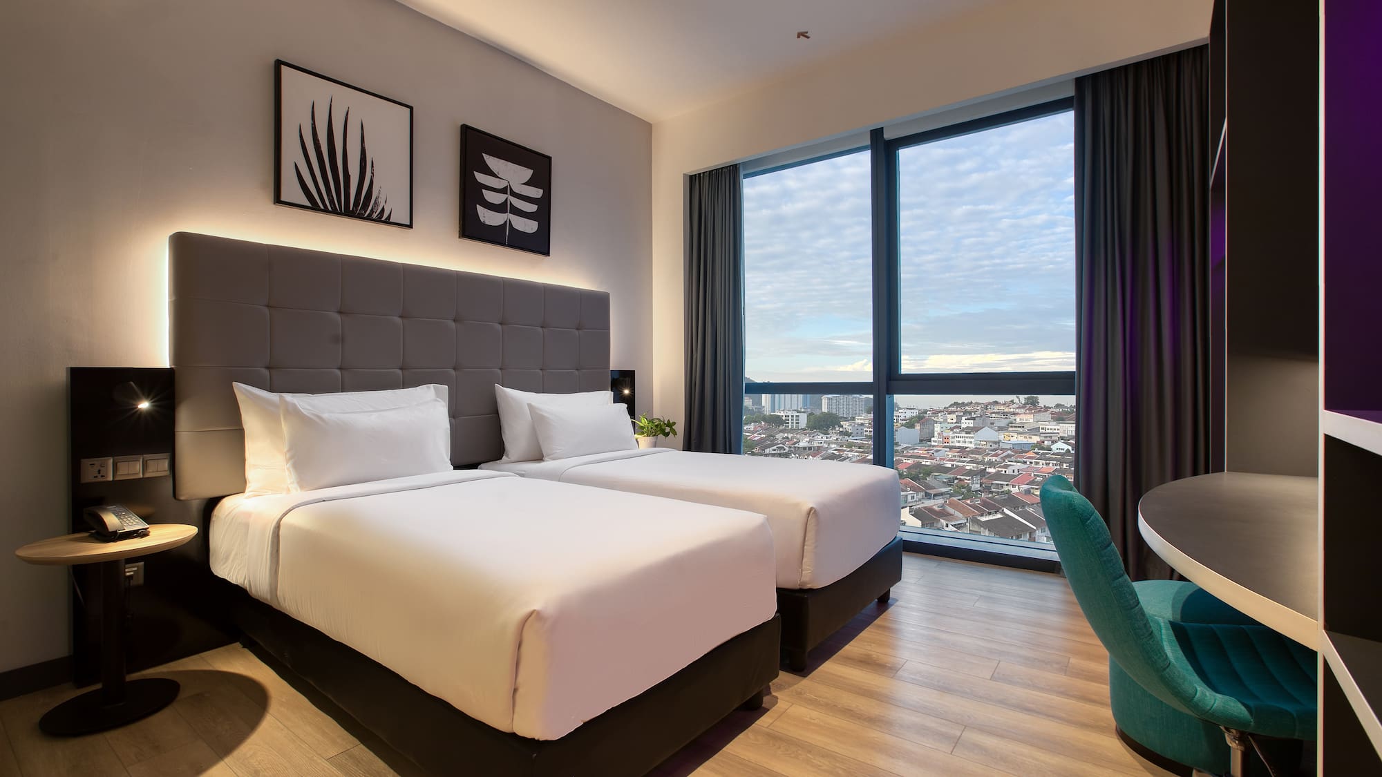 a room with two beds and a chair and a table