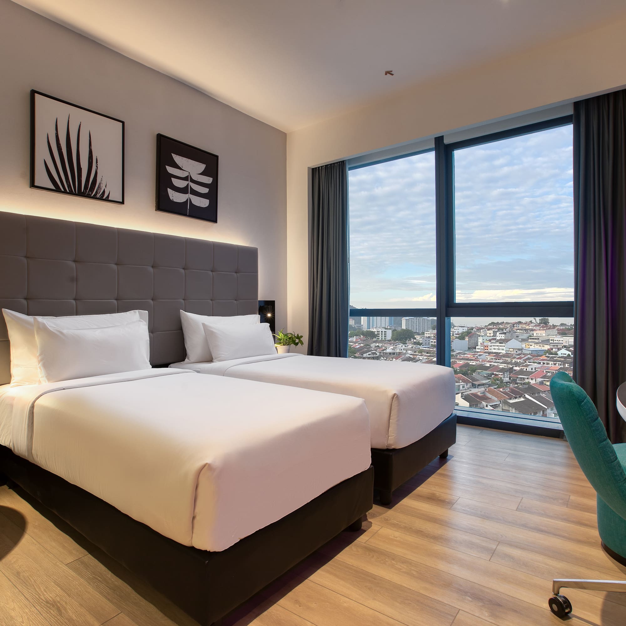 a room with two beds and a chair and a table