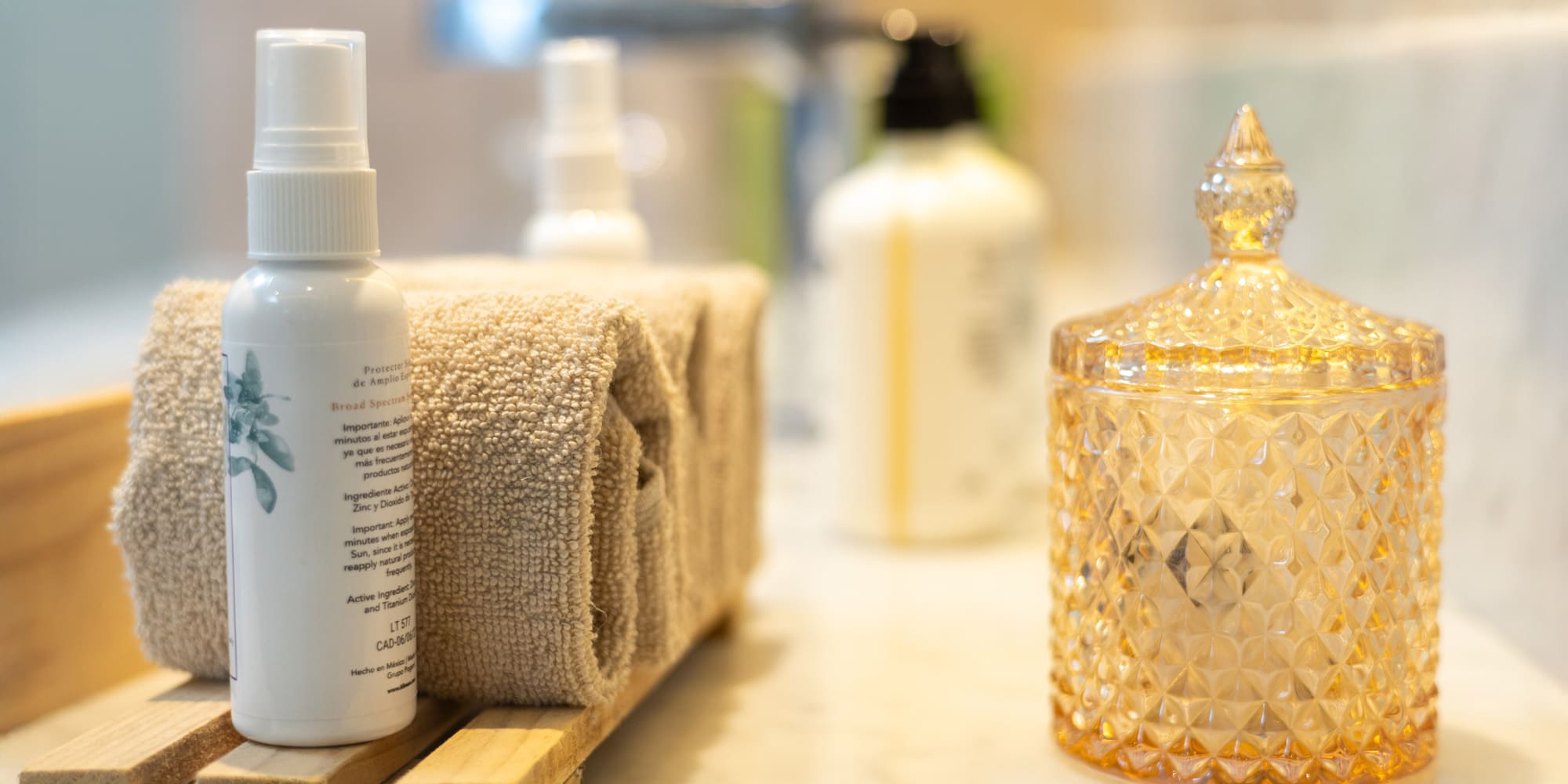 a group of towels and a bottle of liquid on a counter