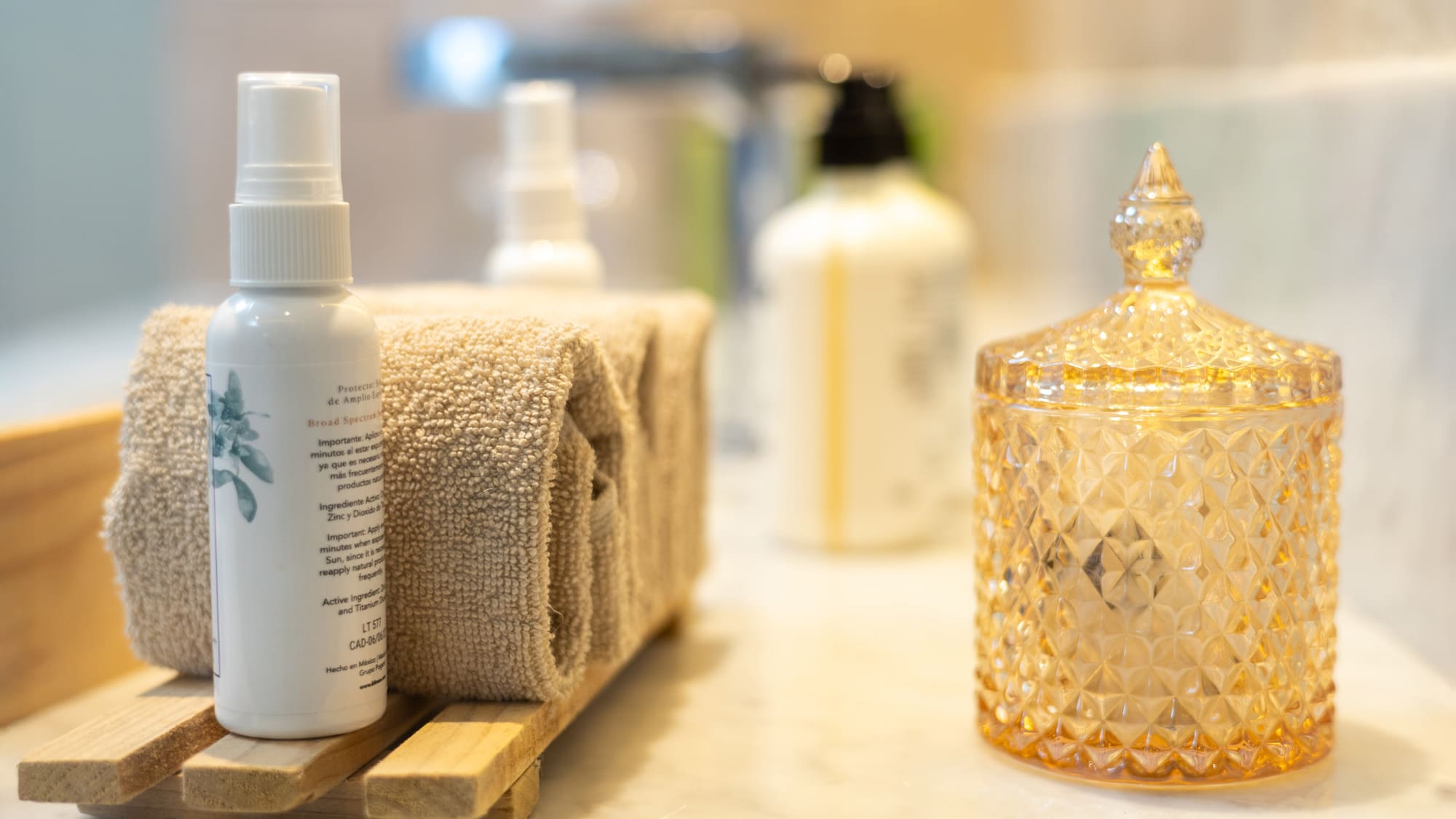 a group of towels and a bottle of liquid on a counter