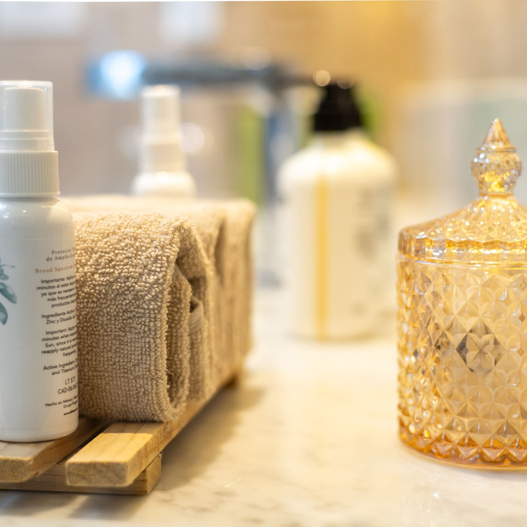 a group of towels and a bottle of liquid on a counter