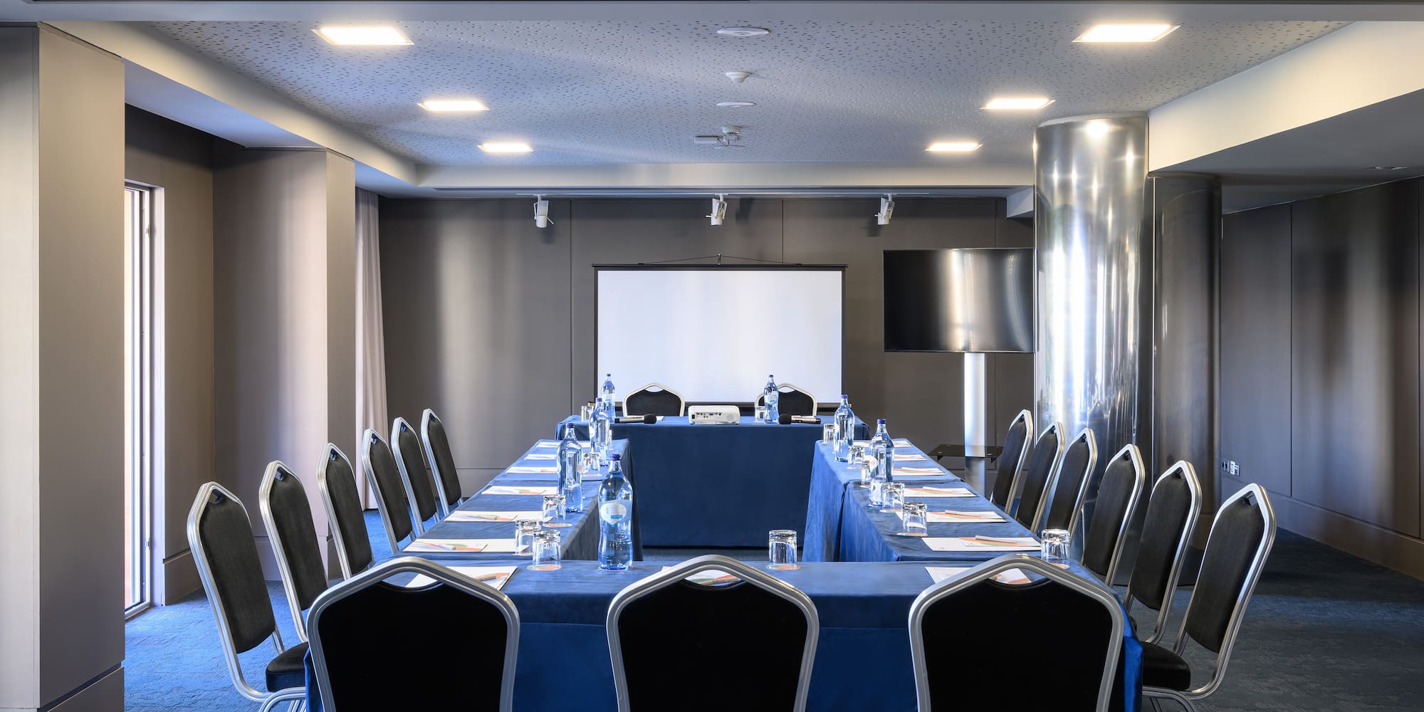a conference room with a table and chairs