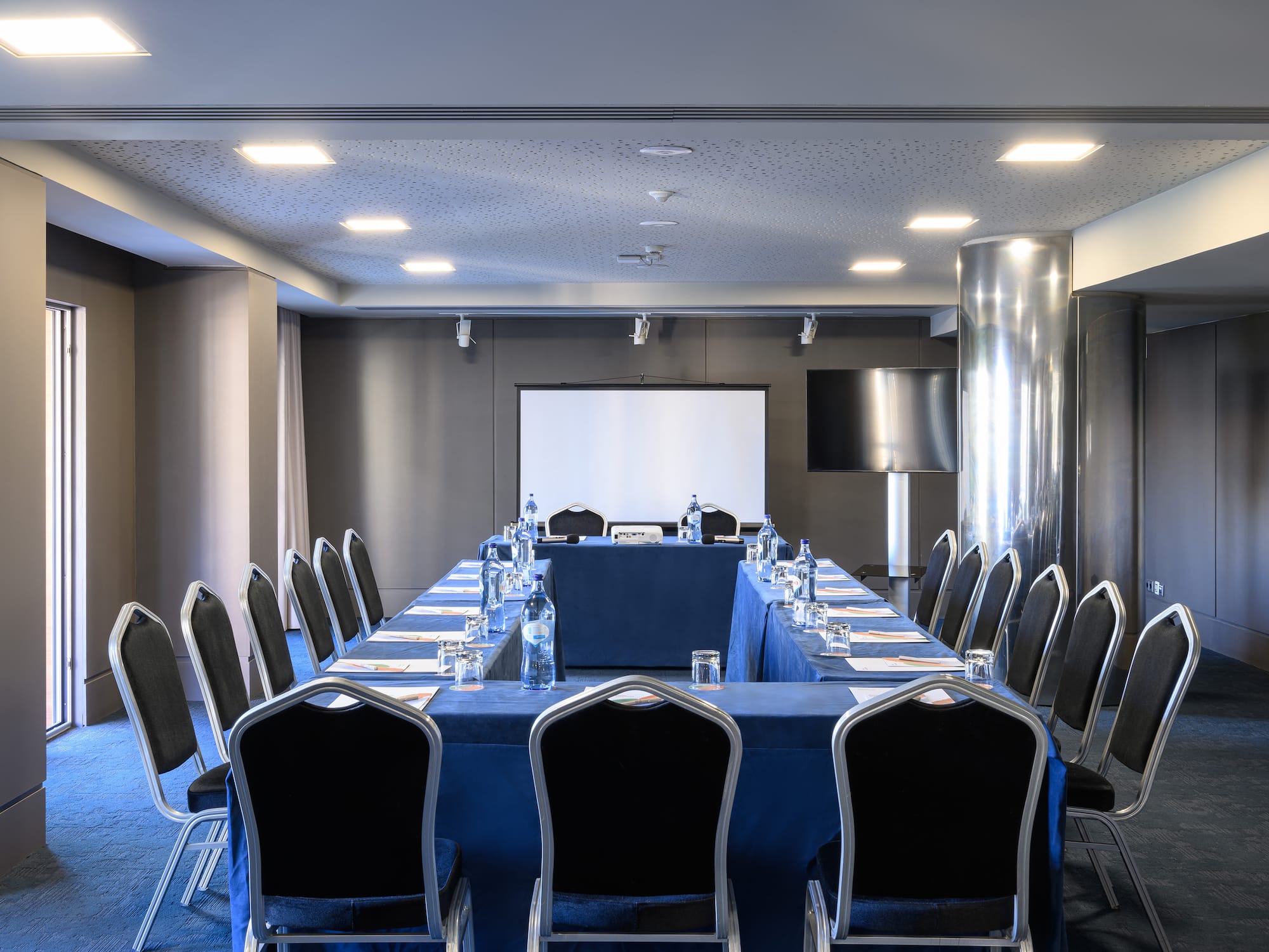 a conference room with a table and chairs