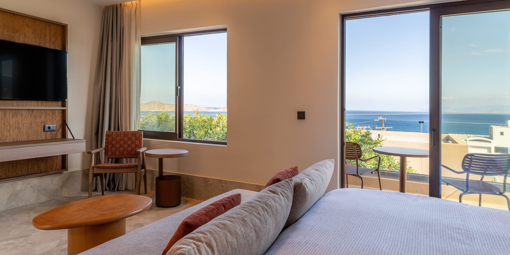 a room with a bed and chairs and a table and chairs