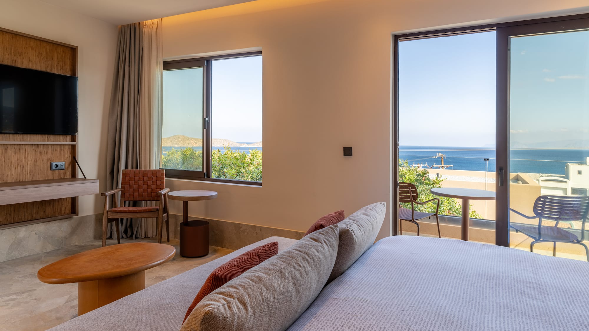 a room with a bed and chairs and a table and chairs