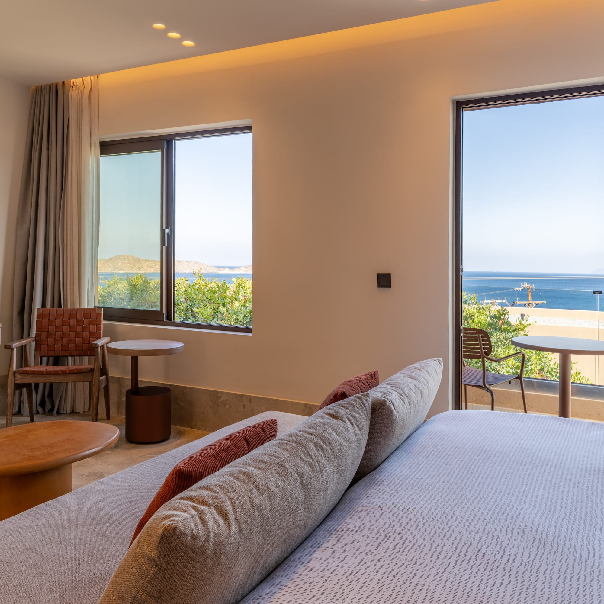 a room with a bed and chairs and a table and chairs