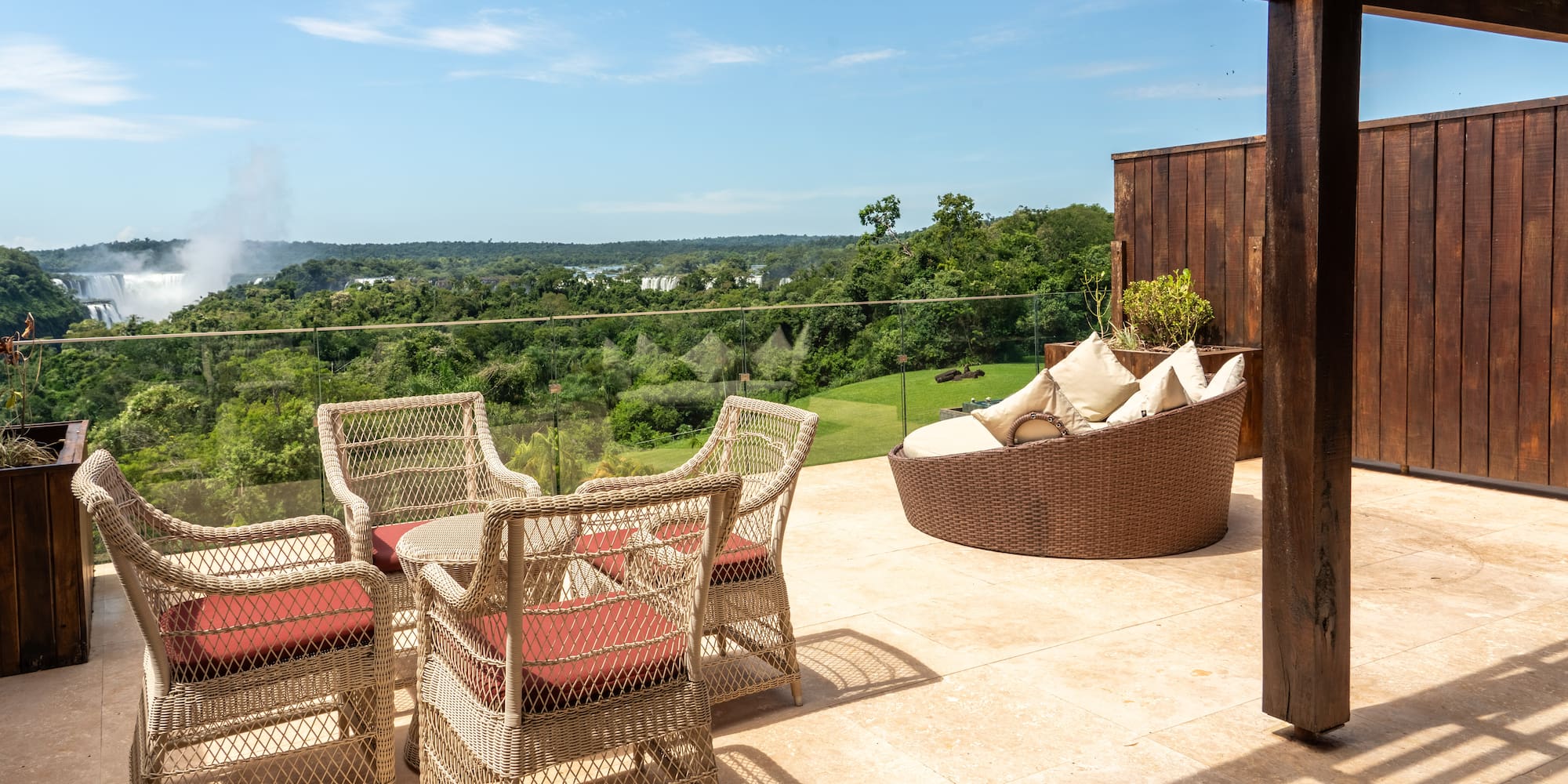 a patio with chairs and a view of the valley