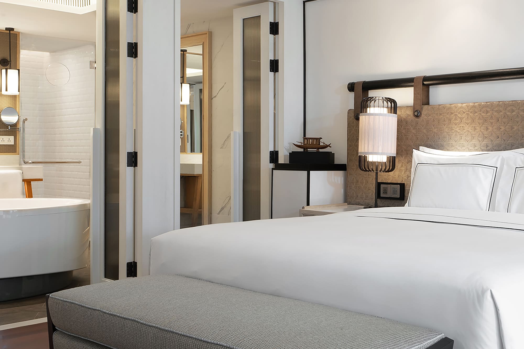 a bed and a bathtub in a hotel room