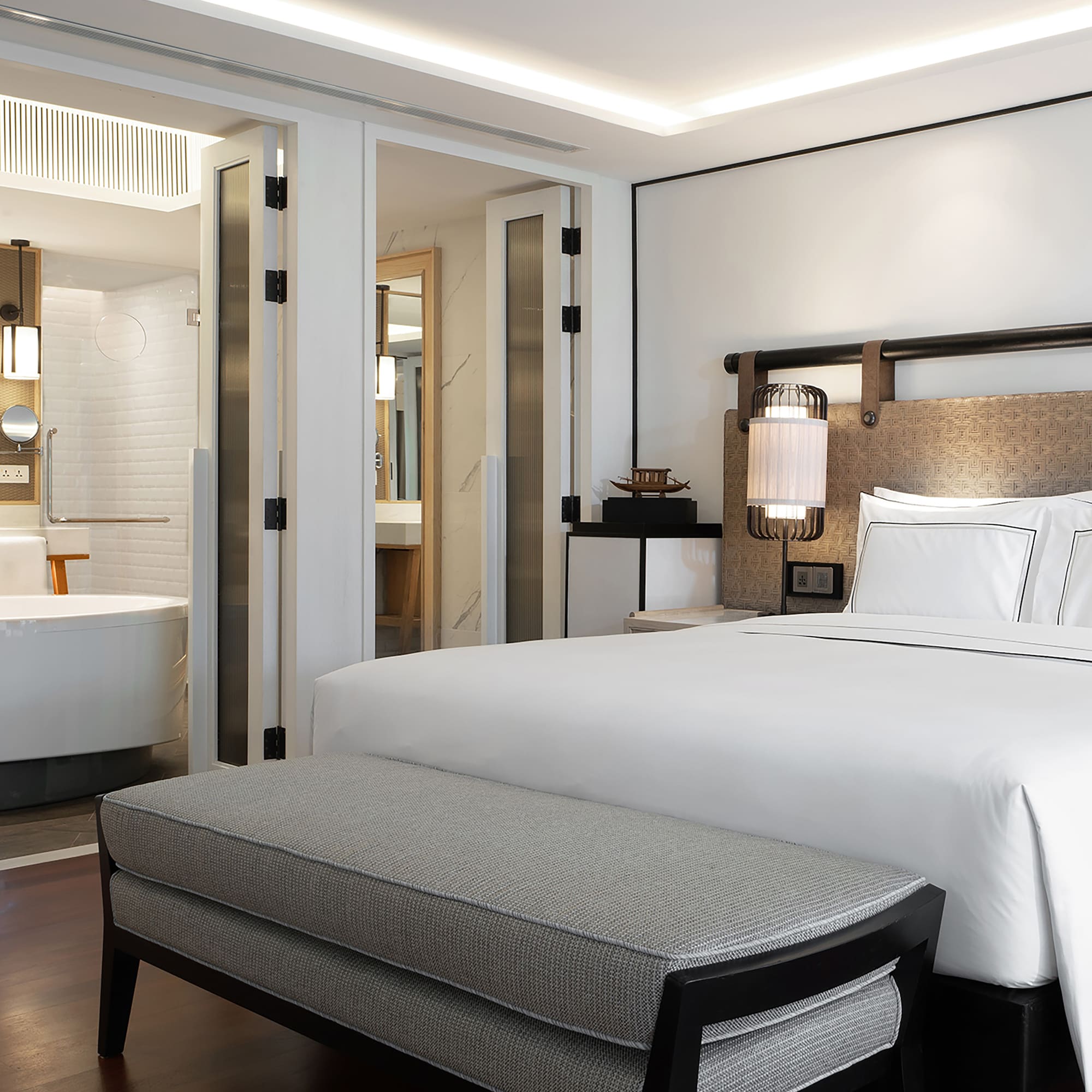 a bed and a bathtub in a hotel room