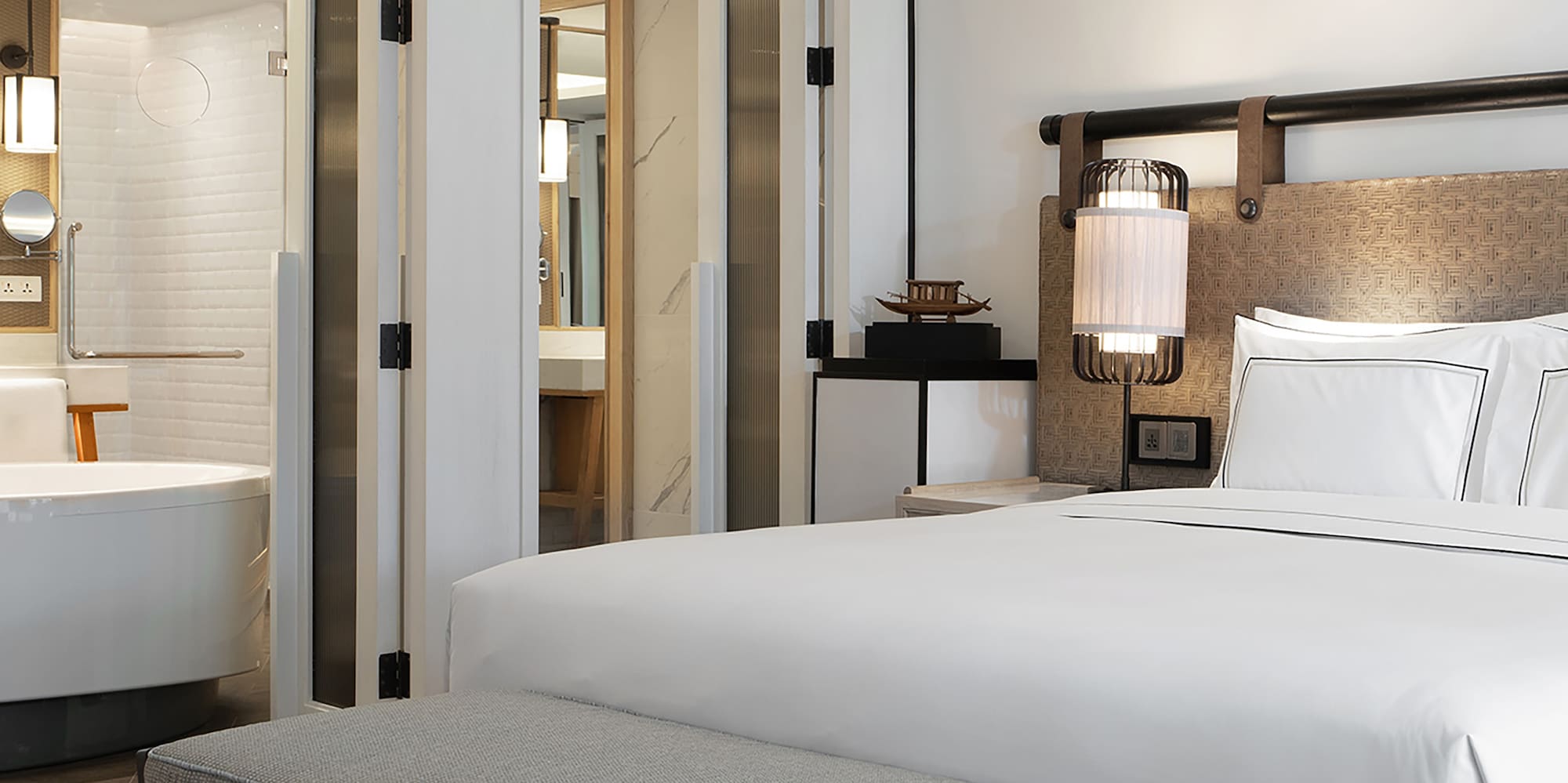 a bed and a bathtub in a hotel room