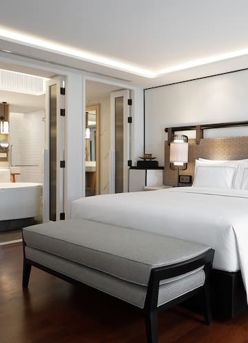 a bed and a bathtub in a hotel room