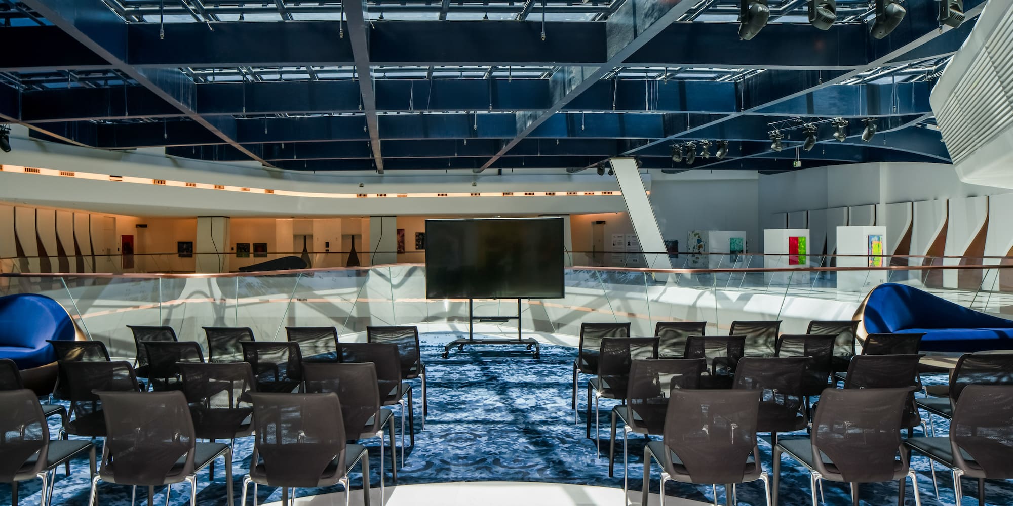 a room with chairs and a screen