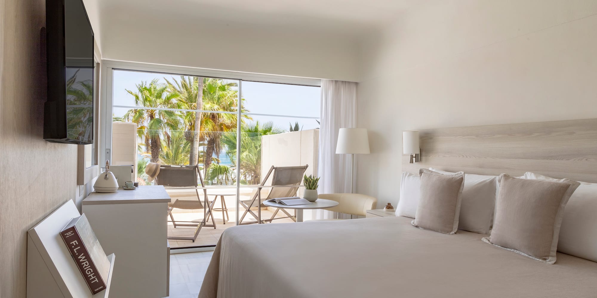 a bedroom with a bed and a table and chairs