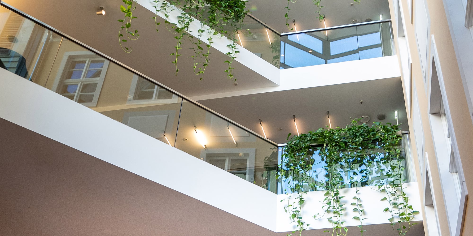 a building with many balconies and plants