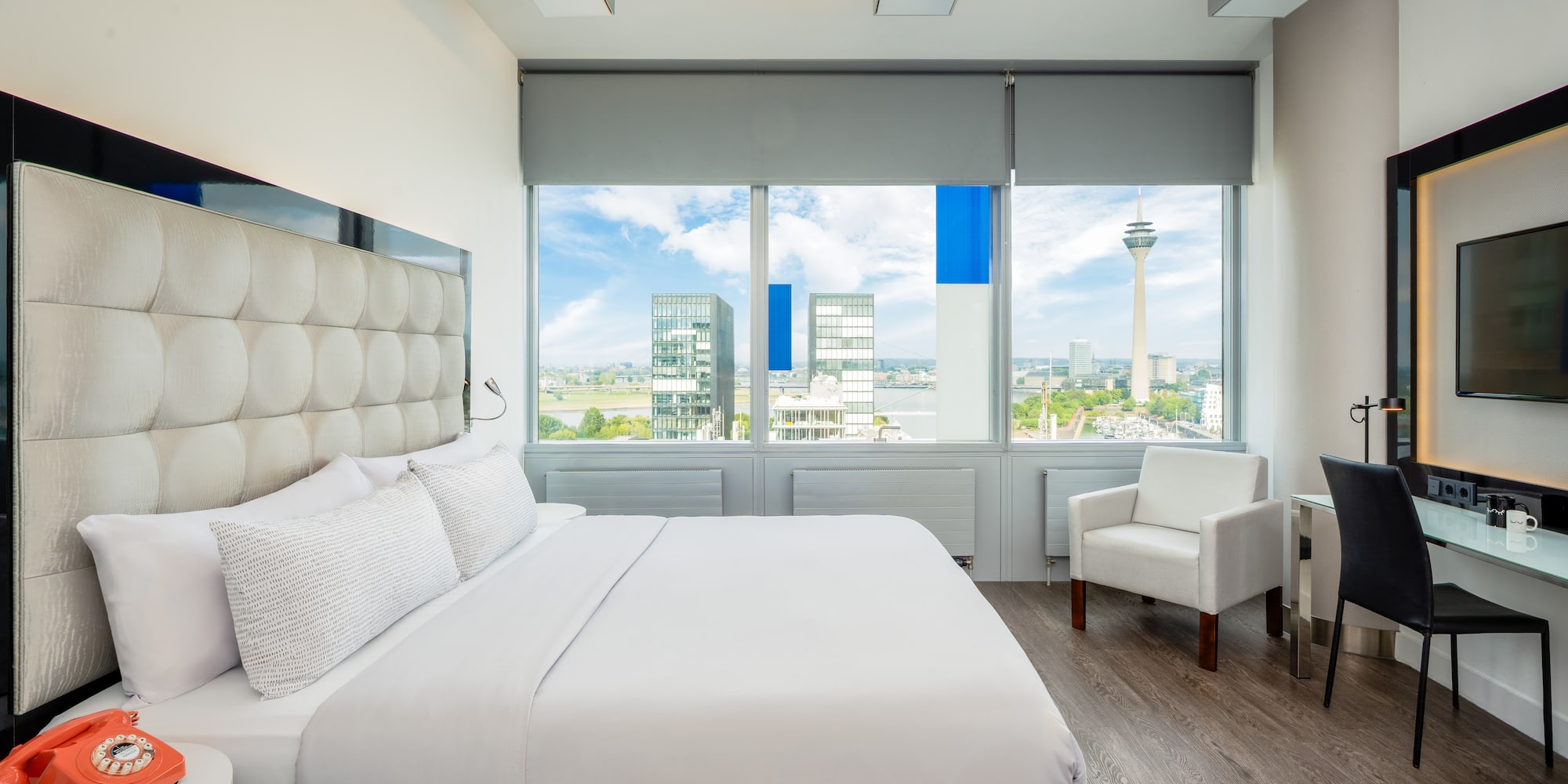 a bedroom with a large bed and chairs