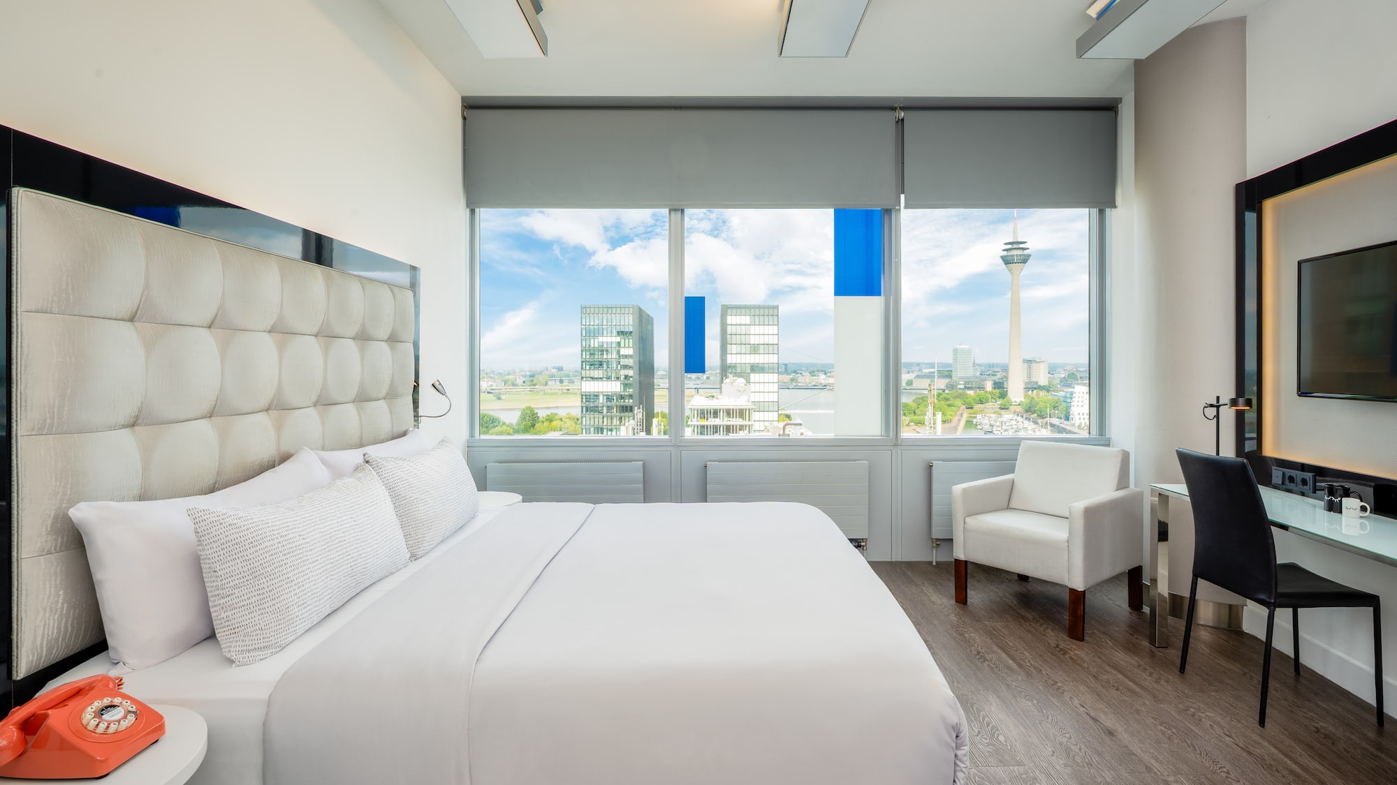 a bedroom with a large bed and chairs