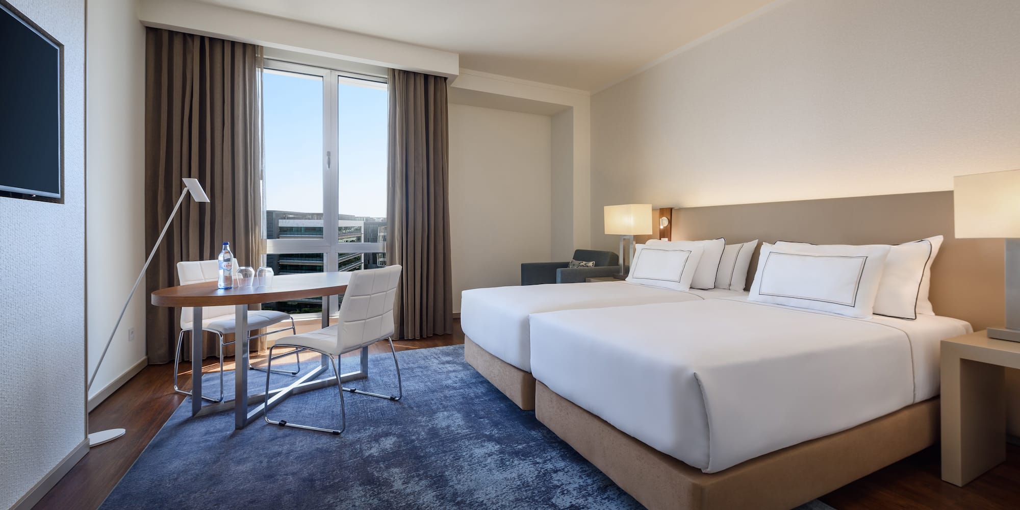 a room with two beds and a table