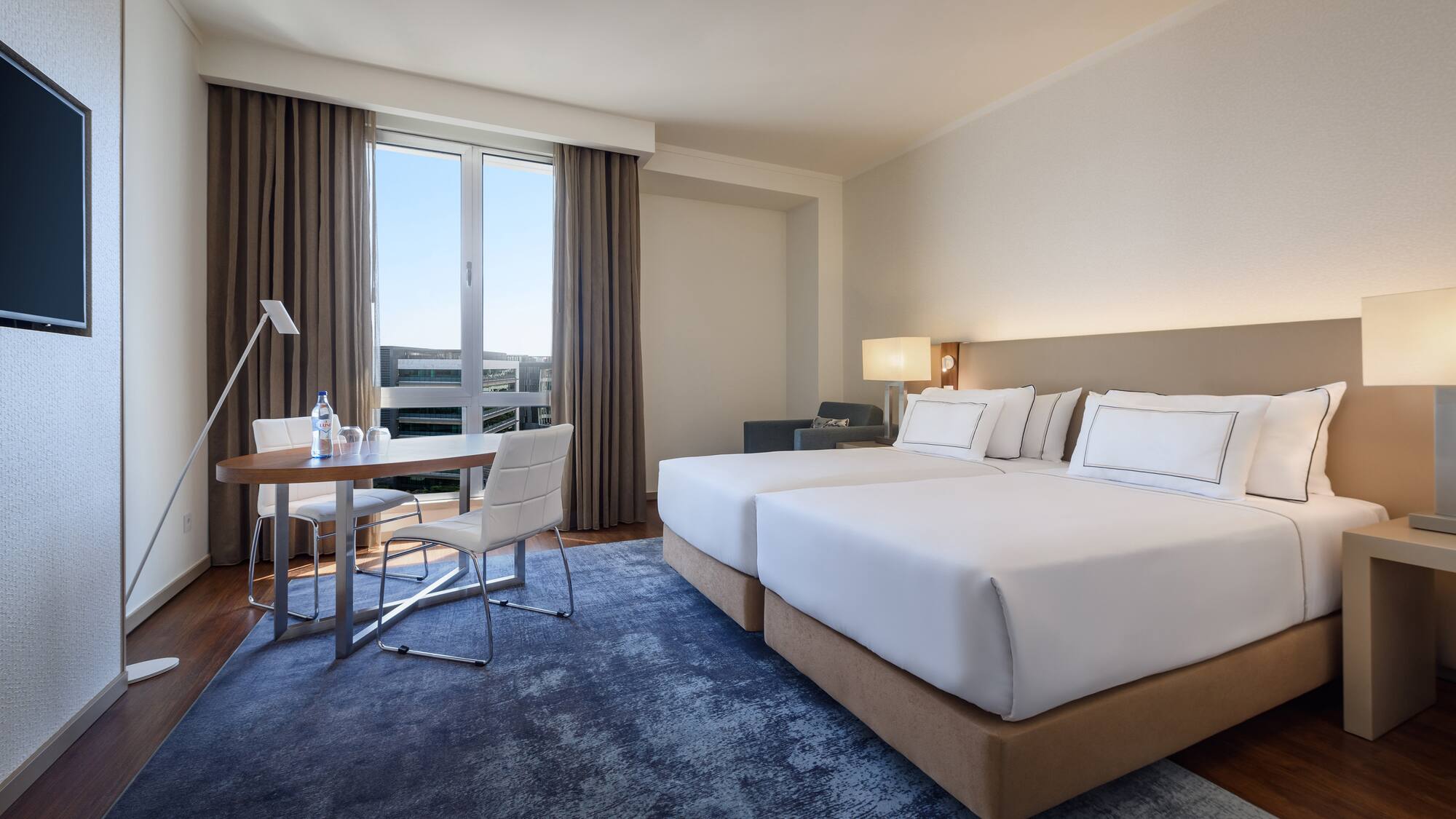 a room with two beds and a table
