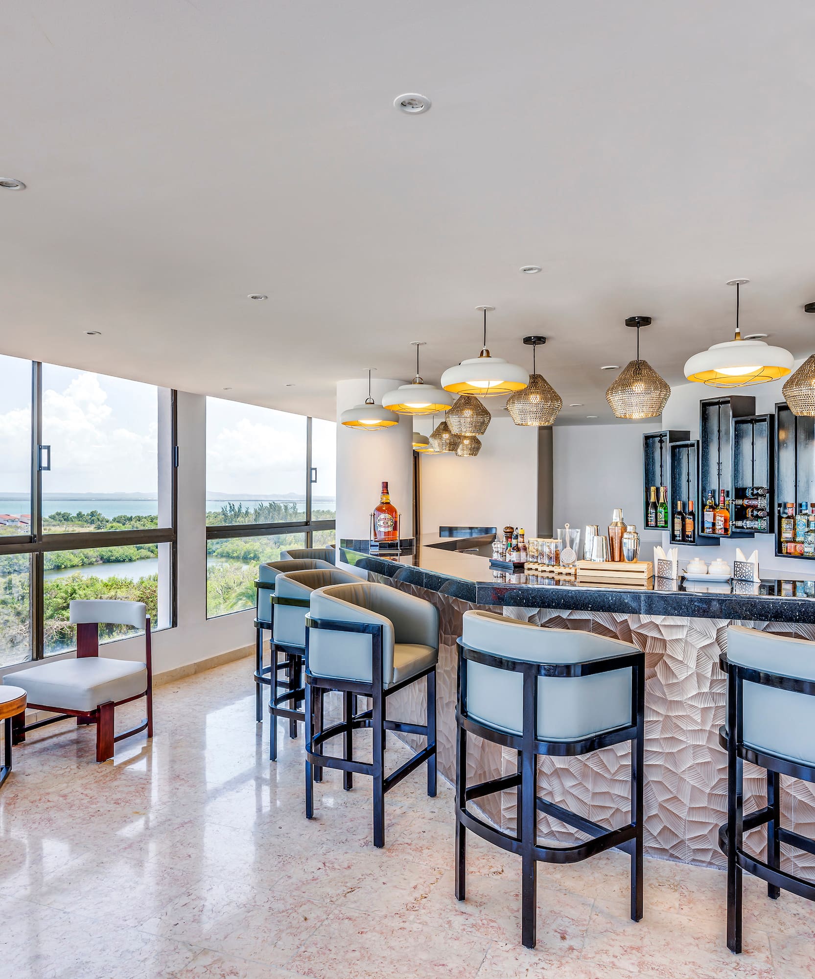 a bar with chairs and a large window
