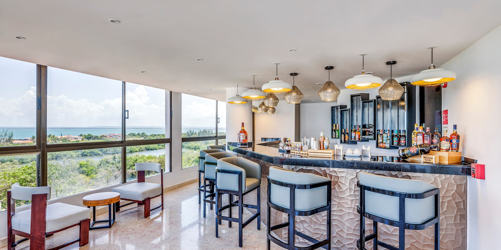 a bar with chairs and a large window