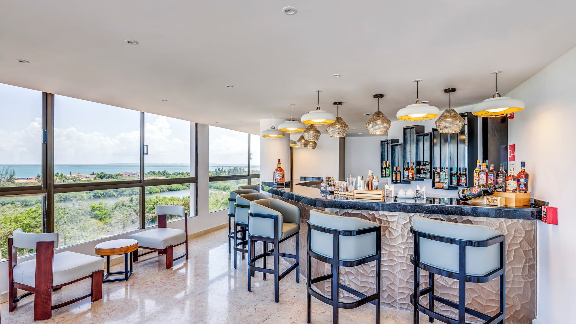 a bar with chairs and a large window