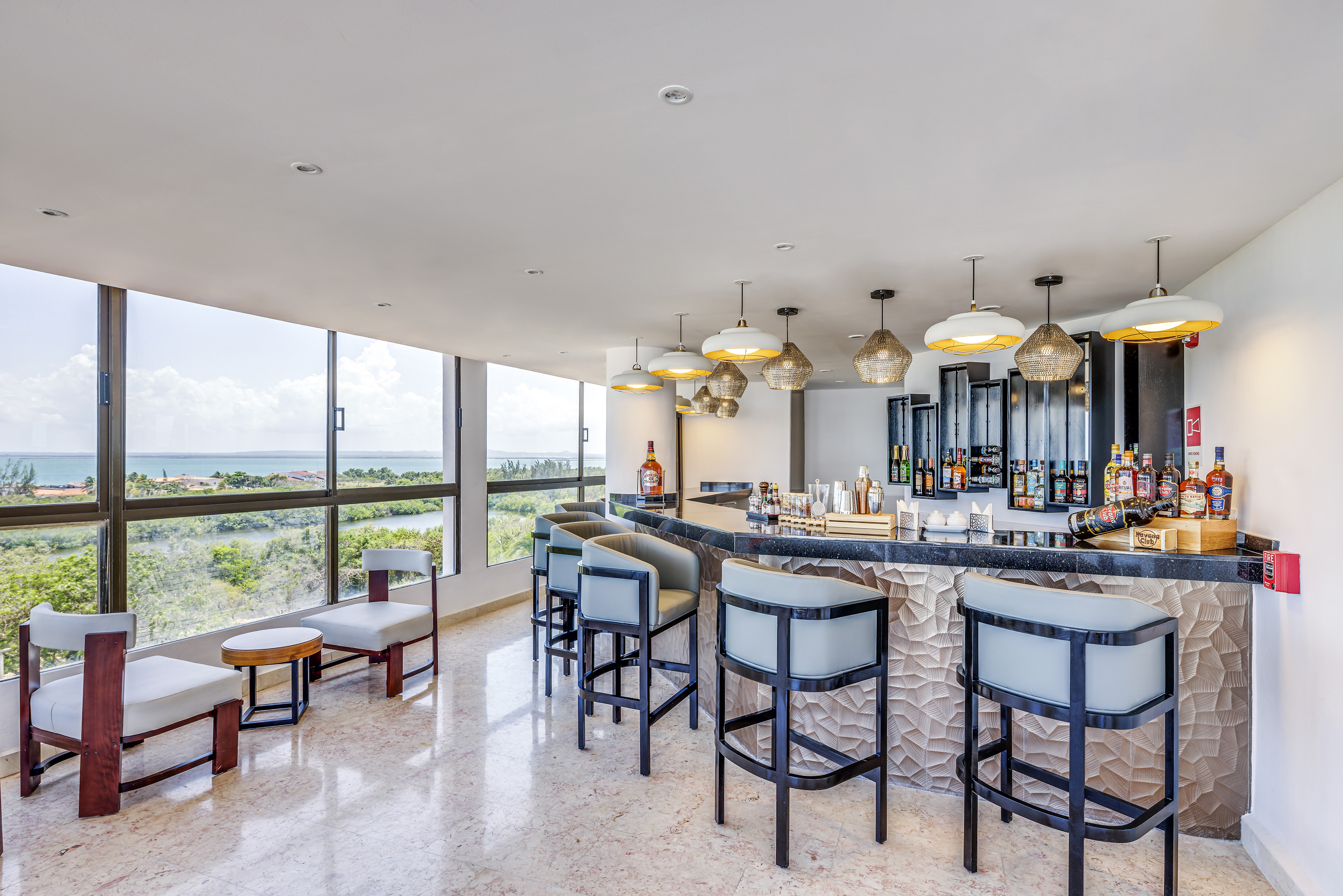 a bar with chairs and a large window