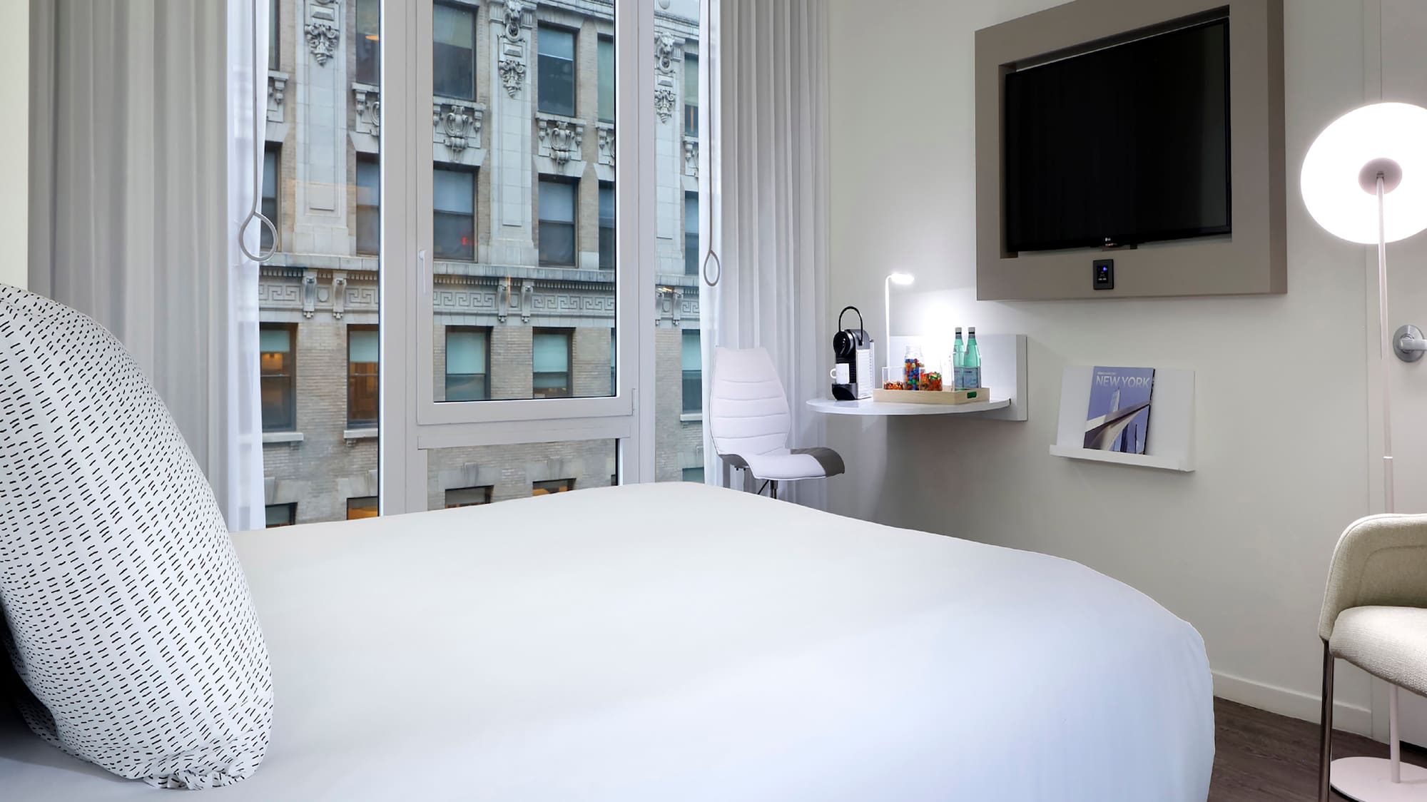 a bedroom with a bed and a television