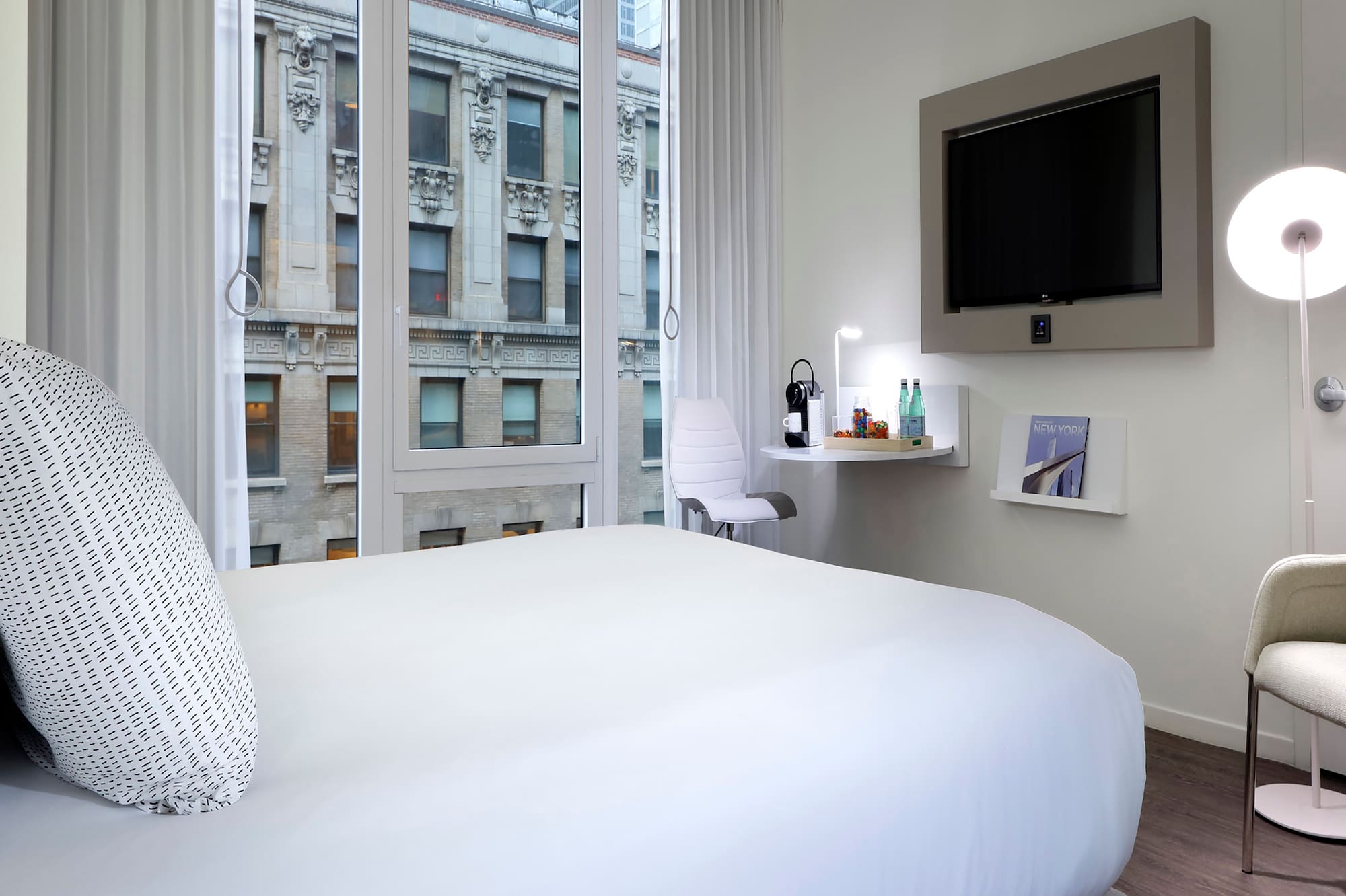 a bedroom with a bed and a television