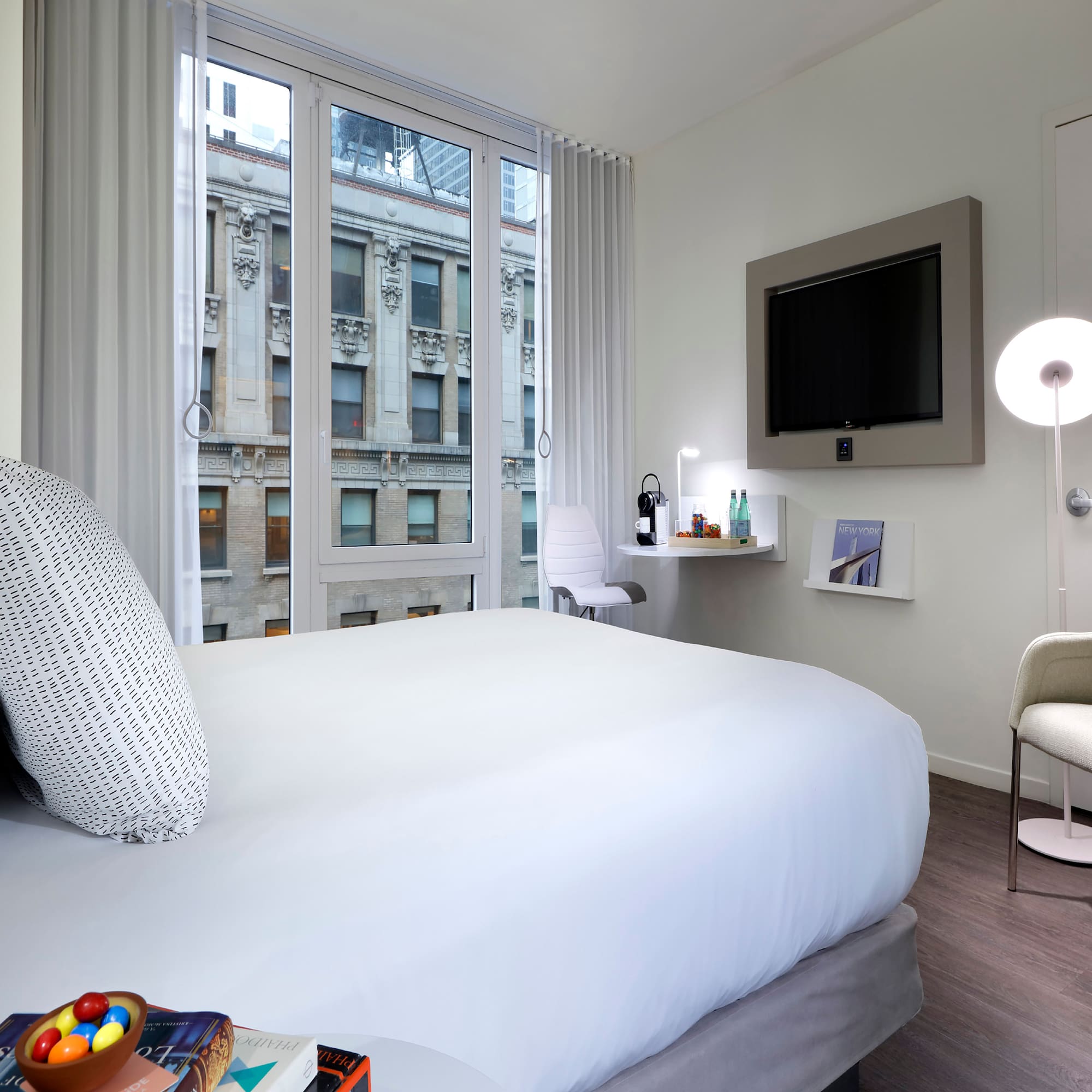 a bedroom with a bed and a television