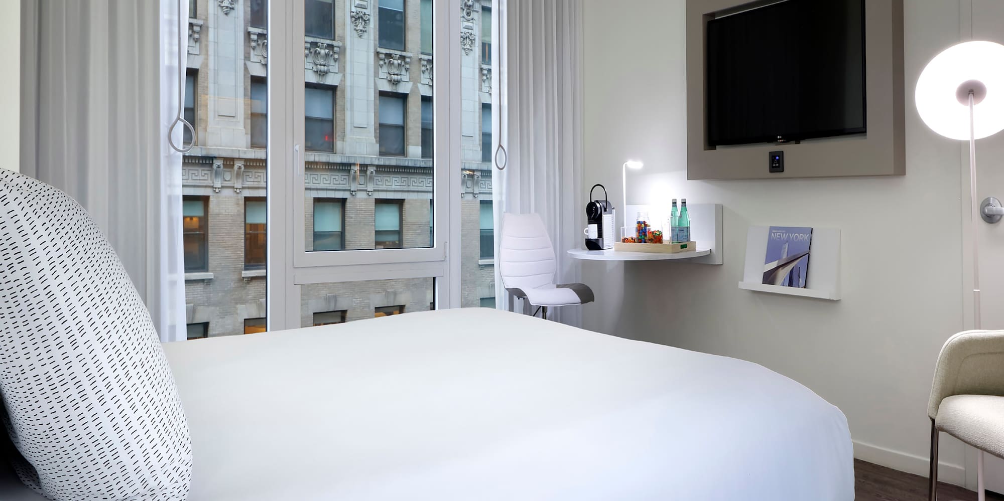 a bedroom with a bed and a television